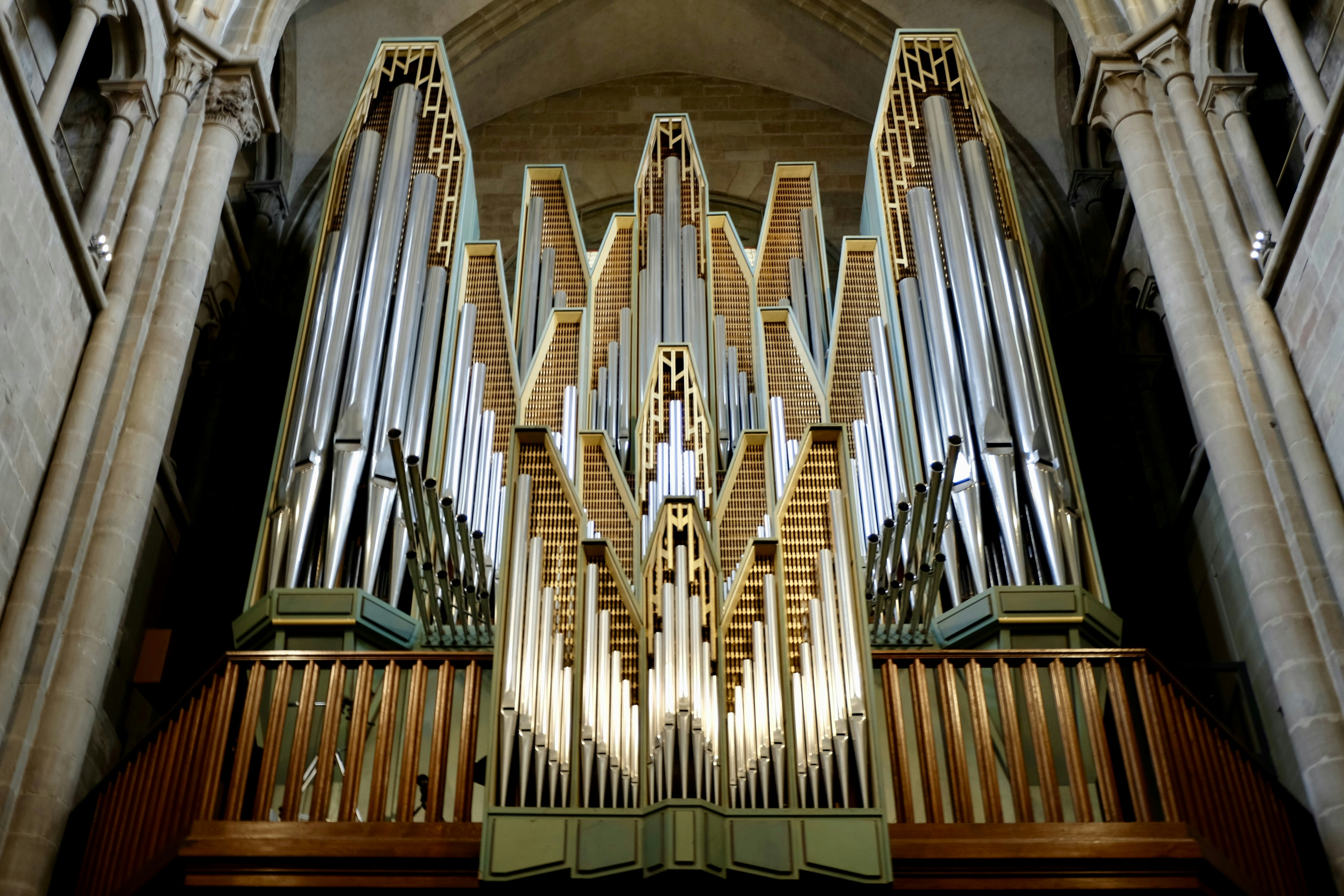 Grand pipe organ inside a cathedral with tall columns