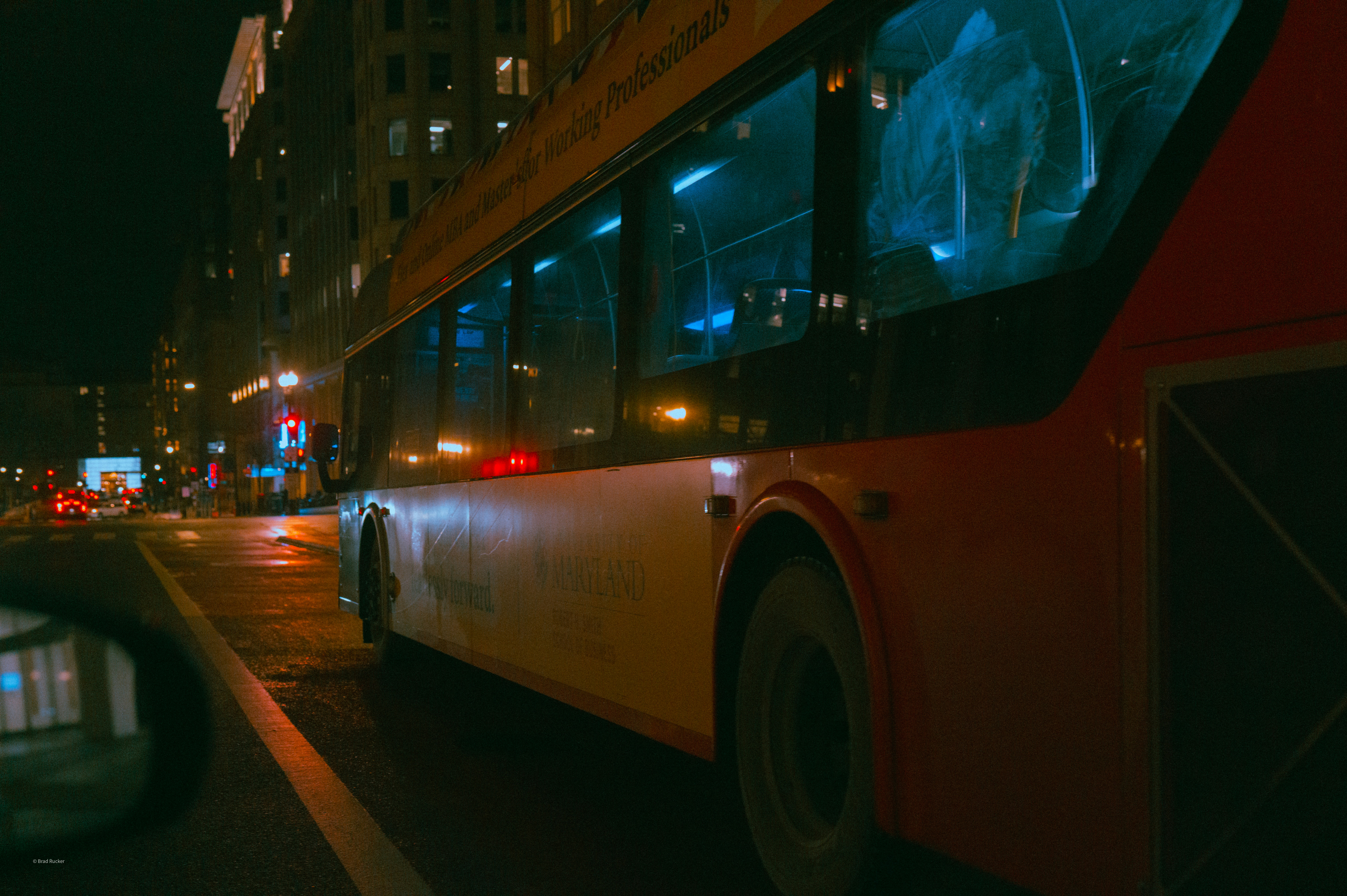 Bus driving on a city street at night