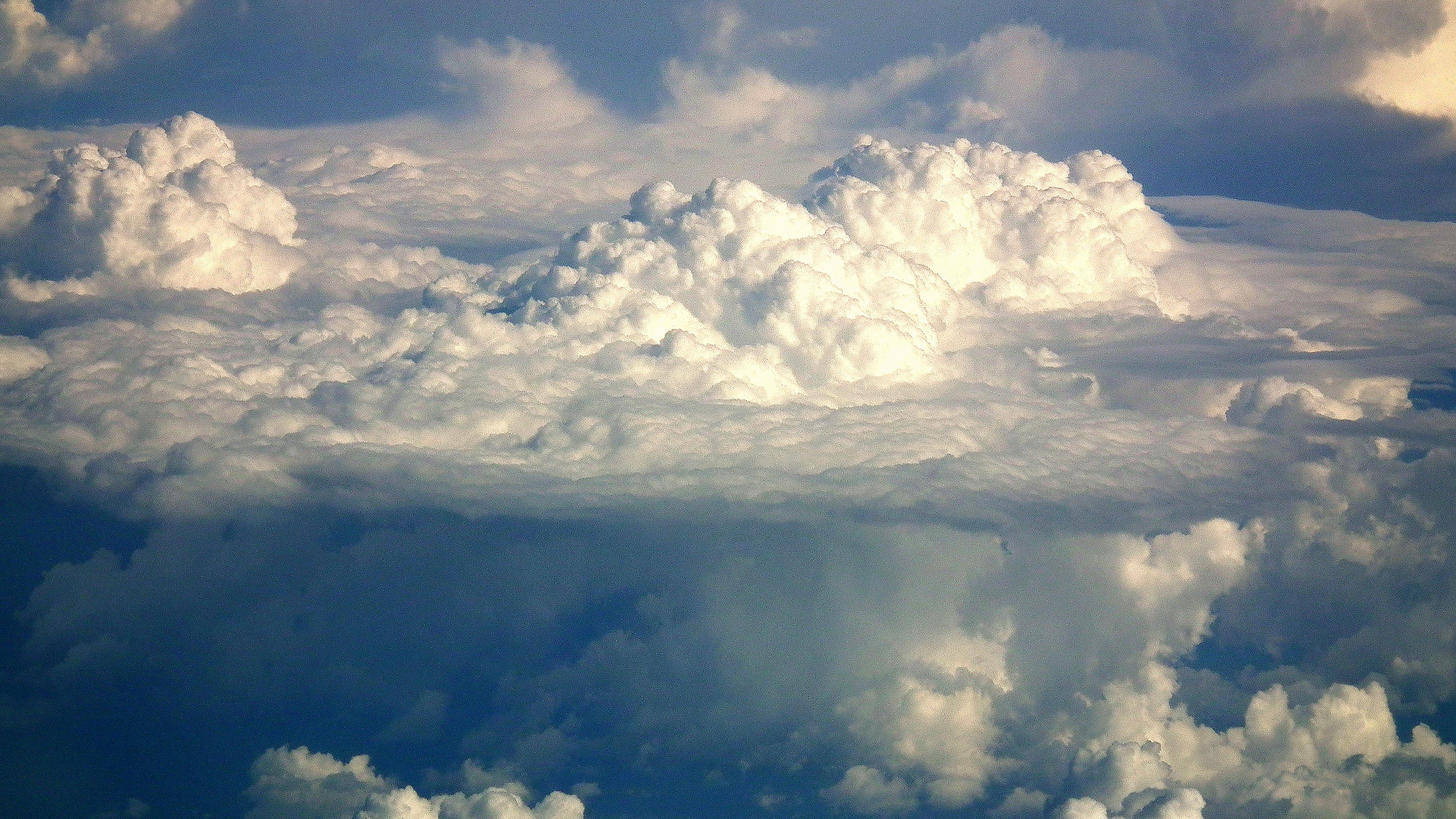Fluffy white clouds against a dark blue sky