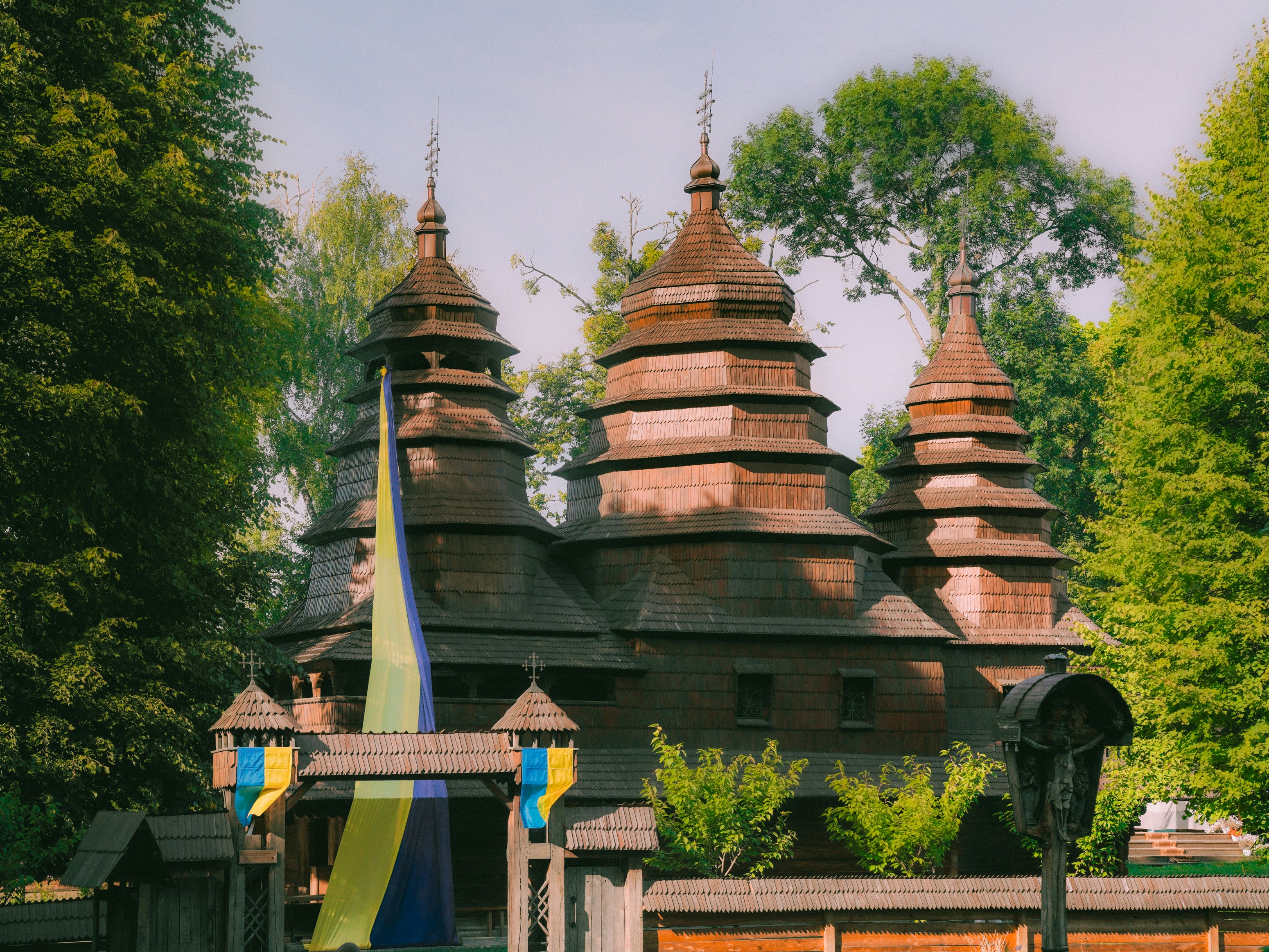 Old wooden church with ukrainian flag