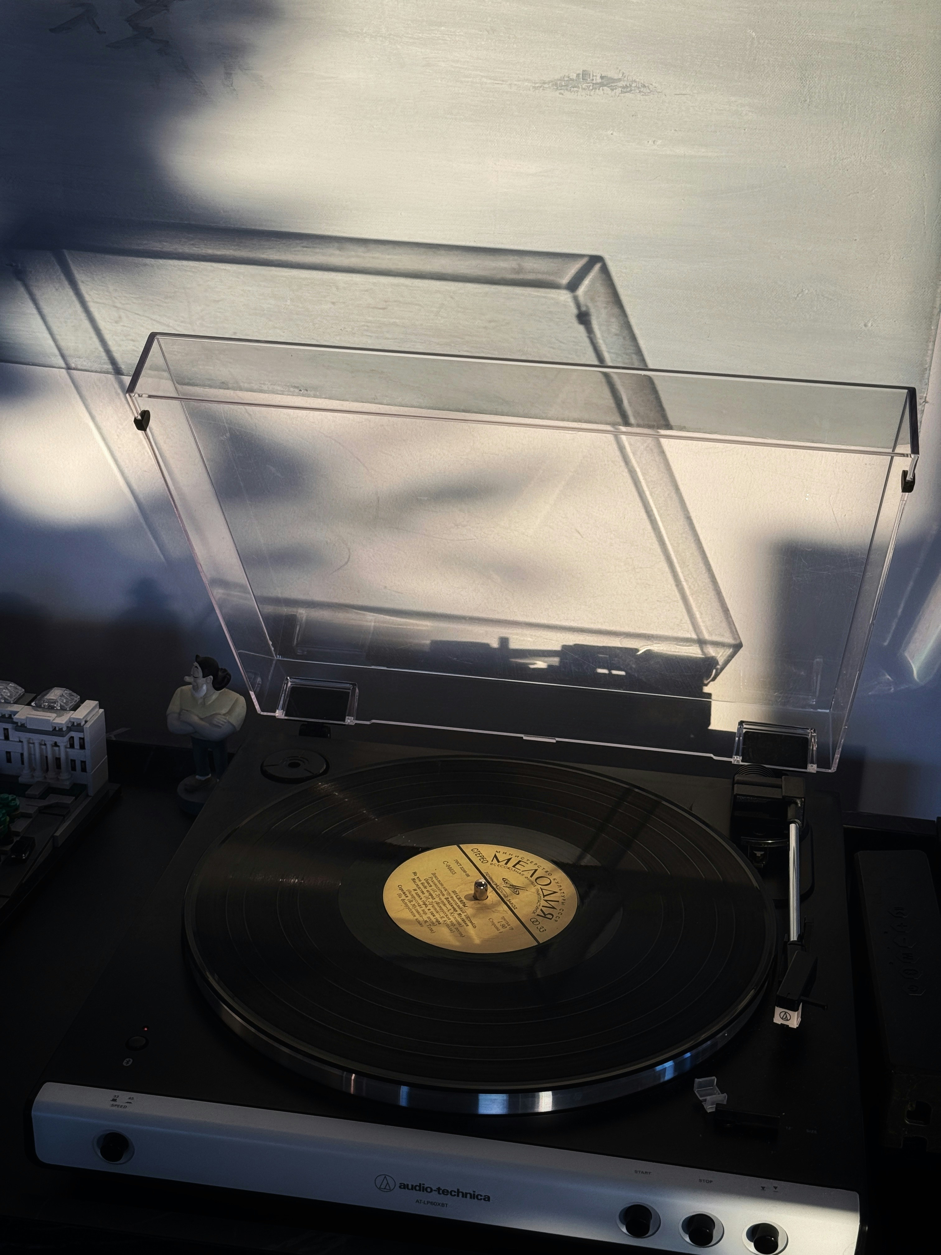A record player with a vinyl record playing.