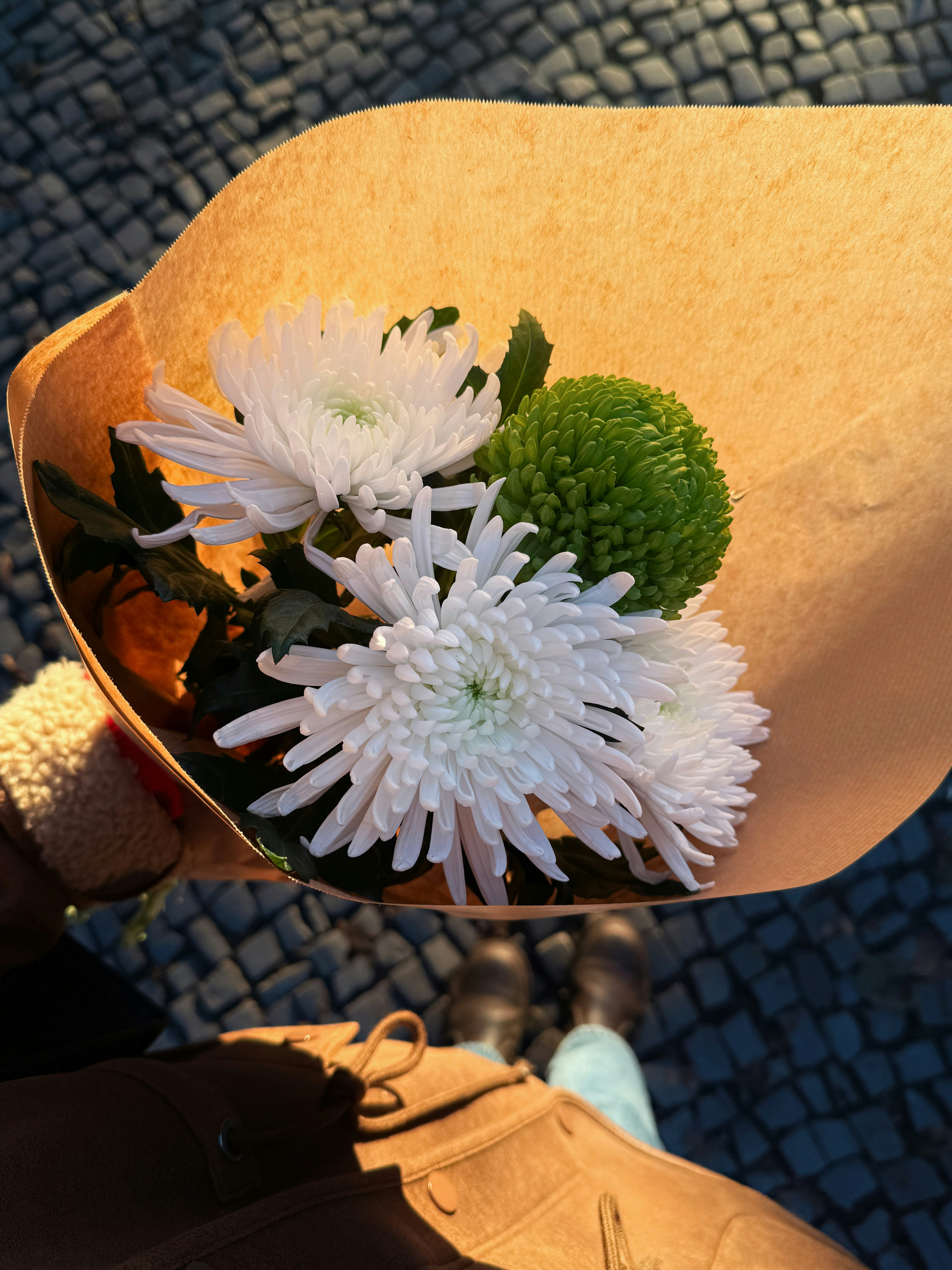 Bouquet of white and green flowers held by hand