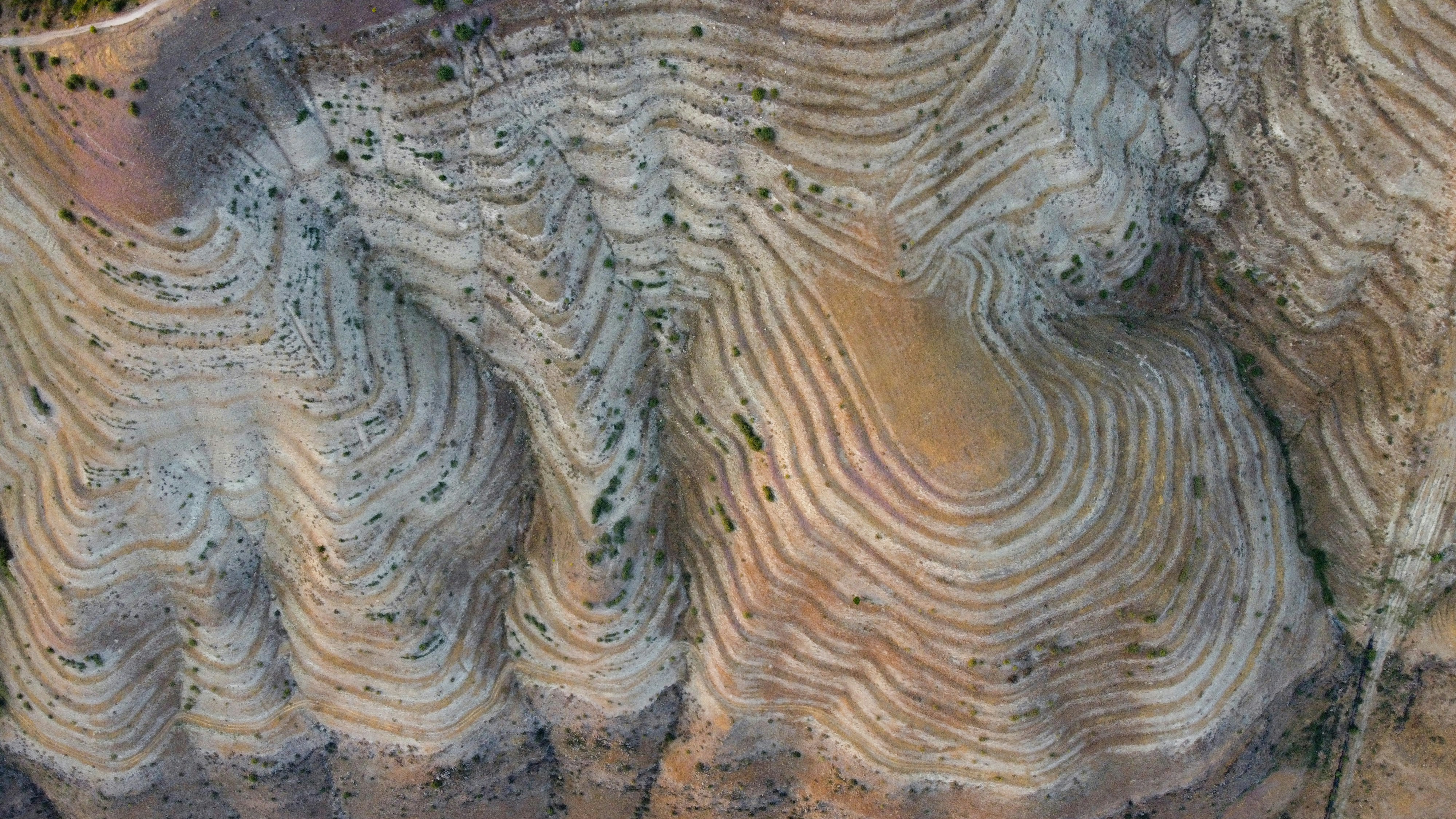 Aerial view of geological rock formations with layered patterns