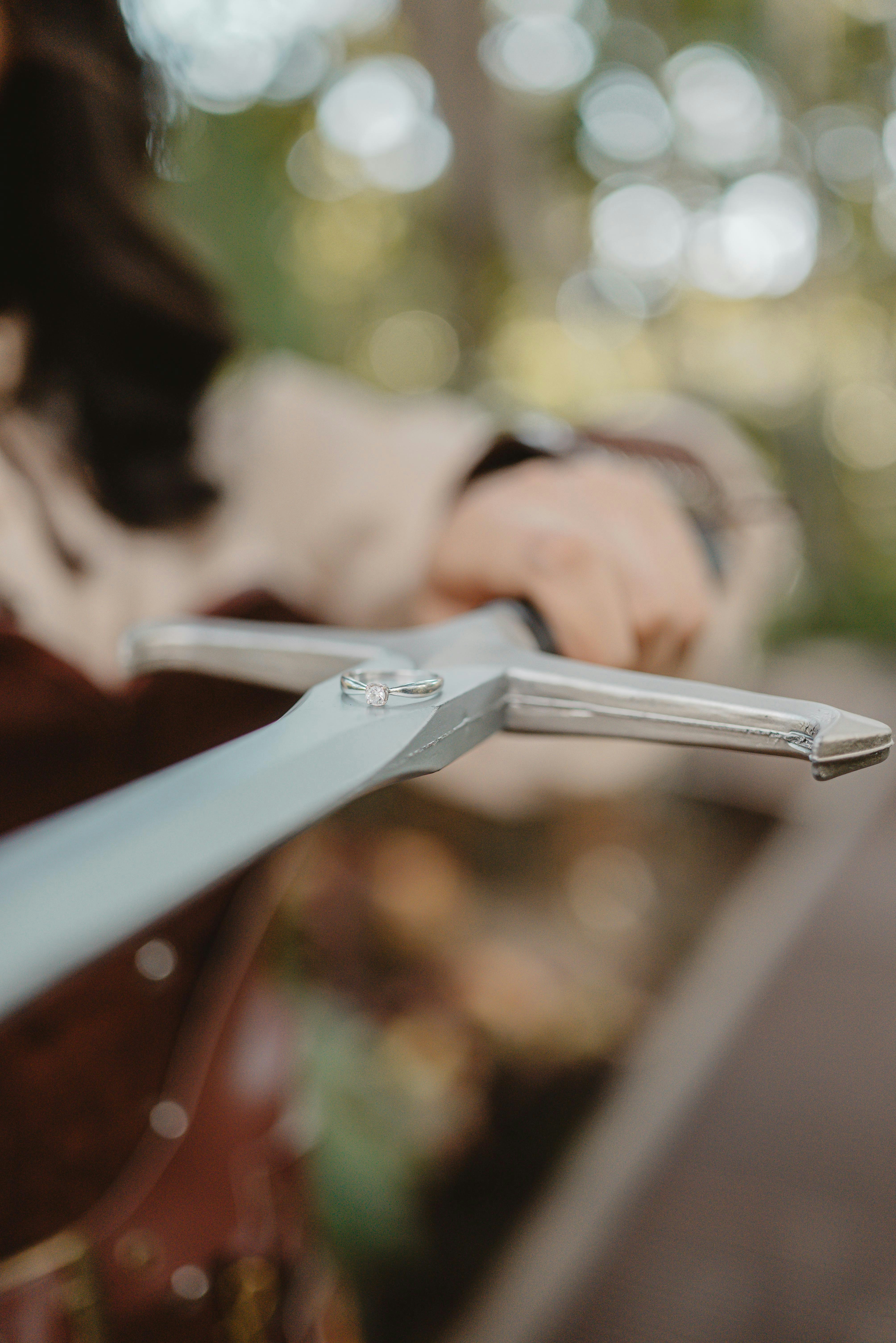 Wedding rings on a sword hilt outdoors