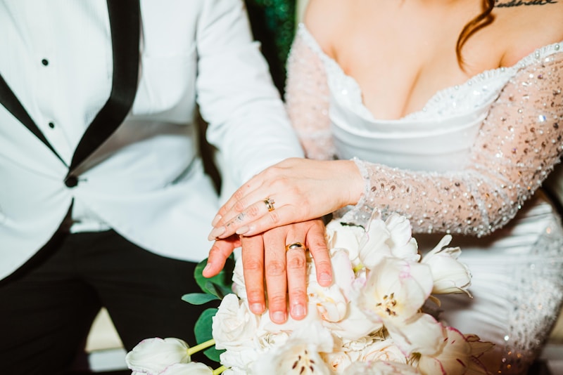 Manos de novia y novio con anillos en ramo