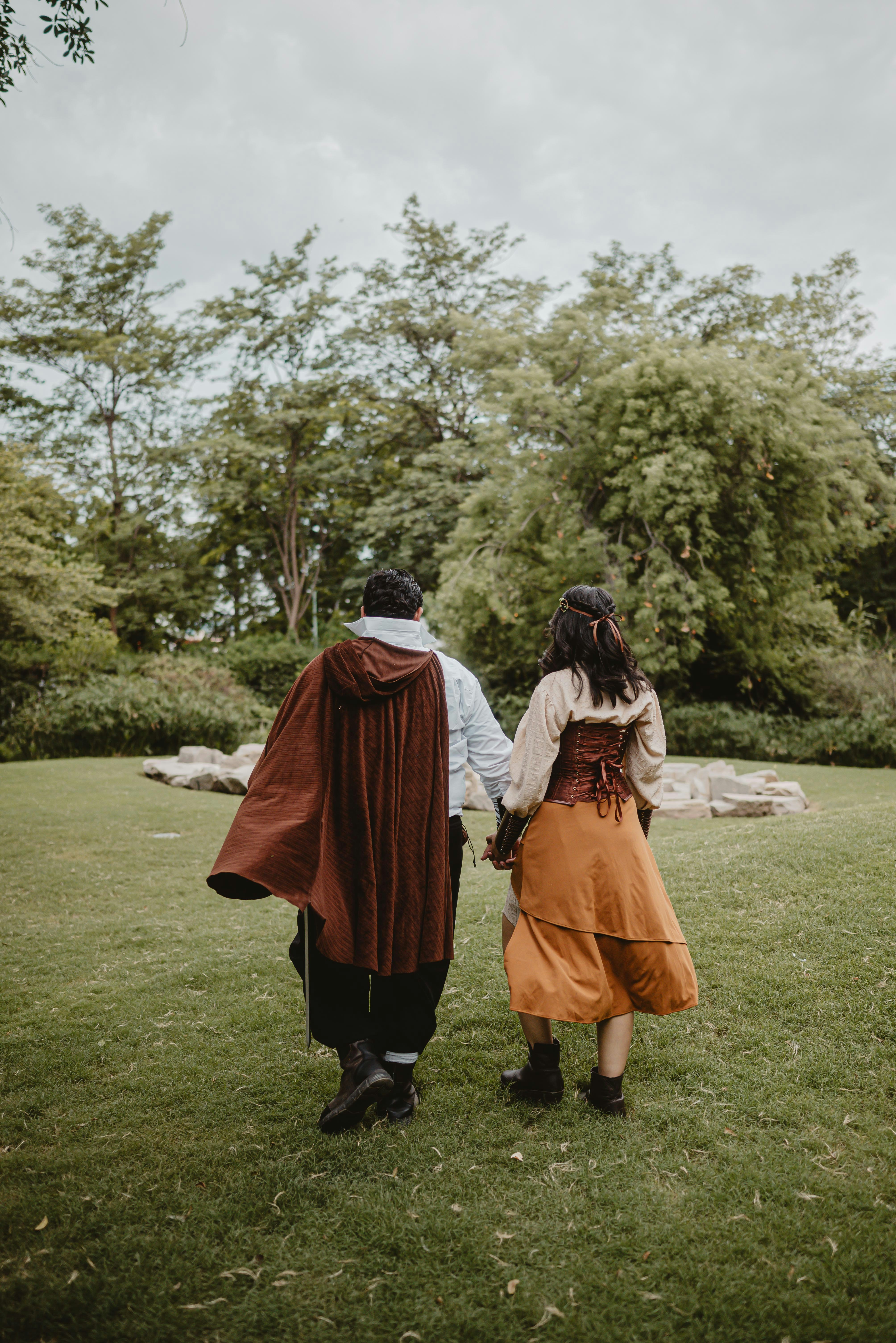 Couple in renaissance attire walking in a park