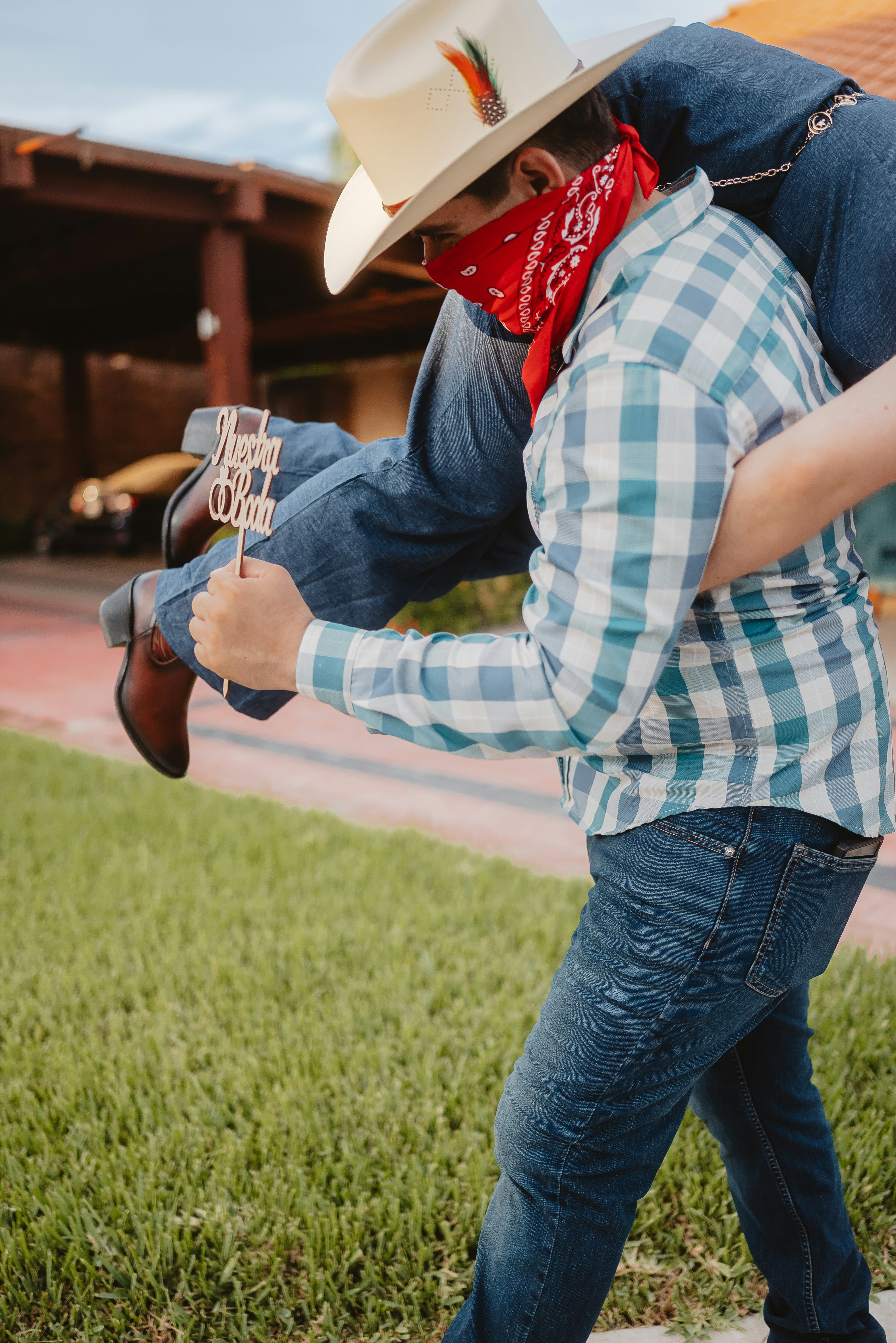 Cowboy carrying another person with a bandana
