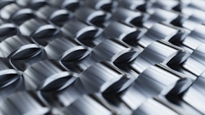 Abstract metallic pattern with repeating geometric shapes.