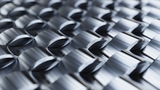 Abstract metallic pattern with repeating geometric shapes.