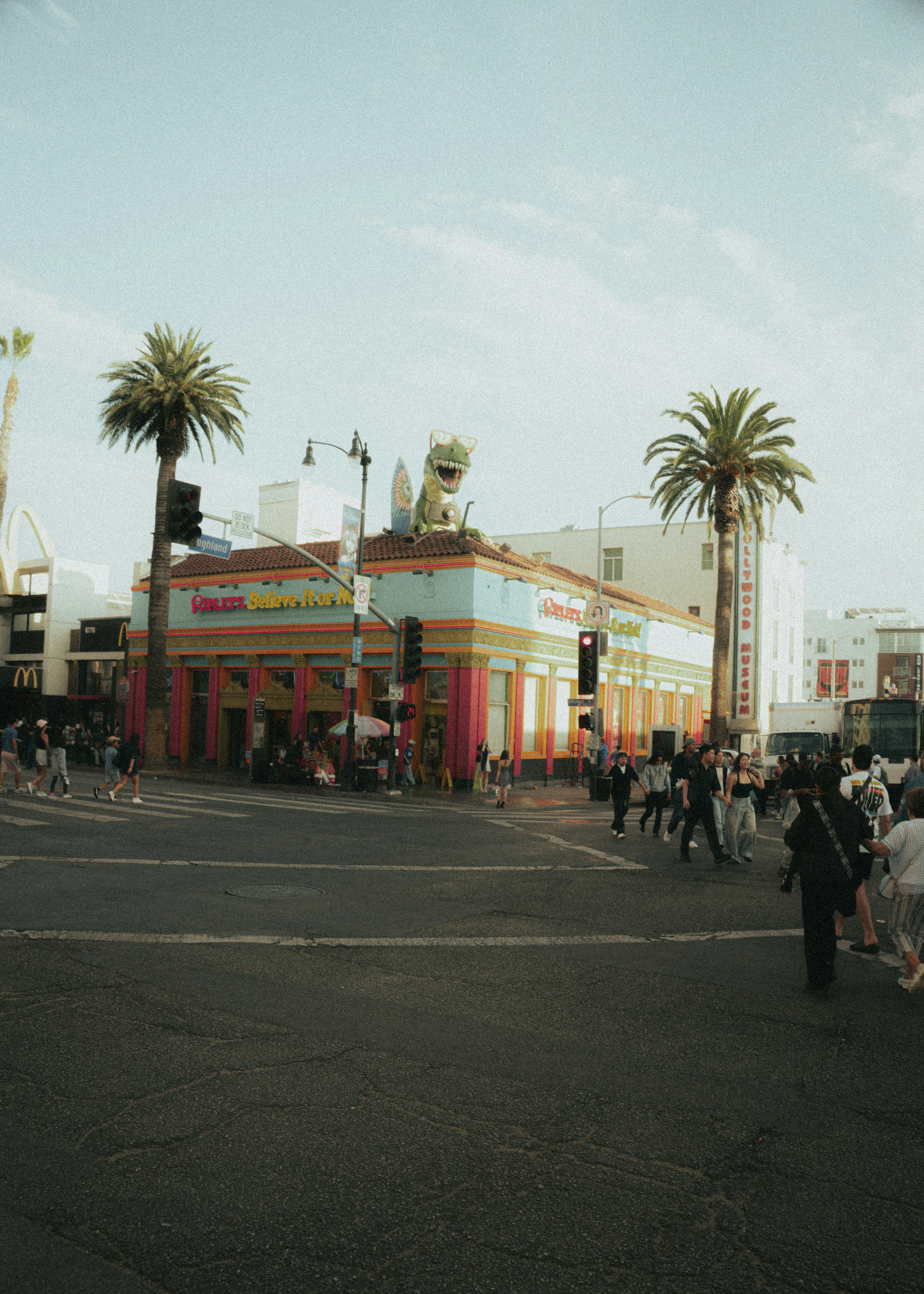 Dinosaur atop colorful building on hollywood boulevard.