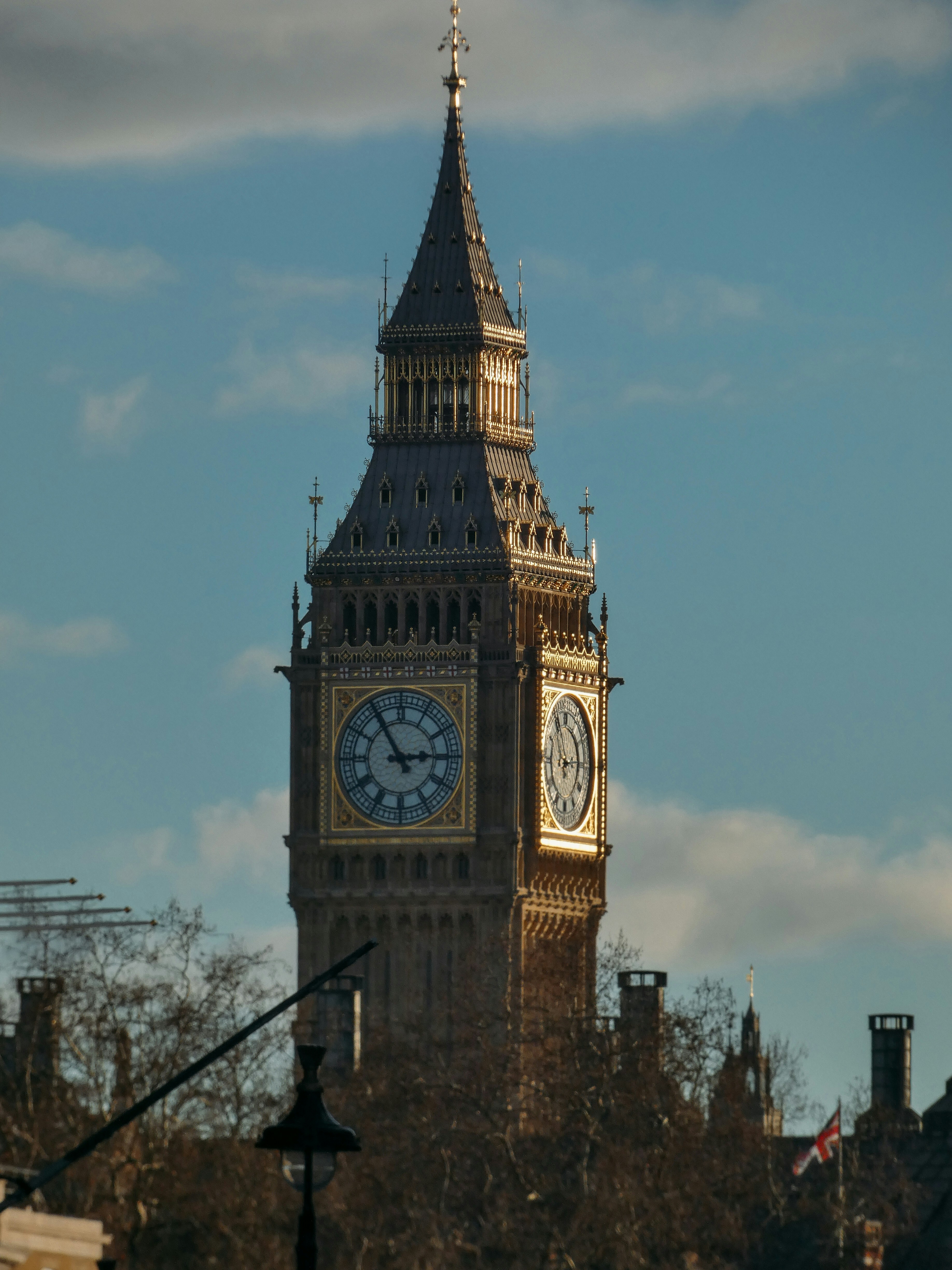 Big ben clock tower against a cloudy blue sky