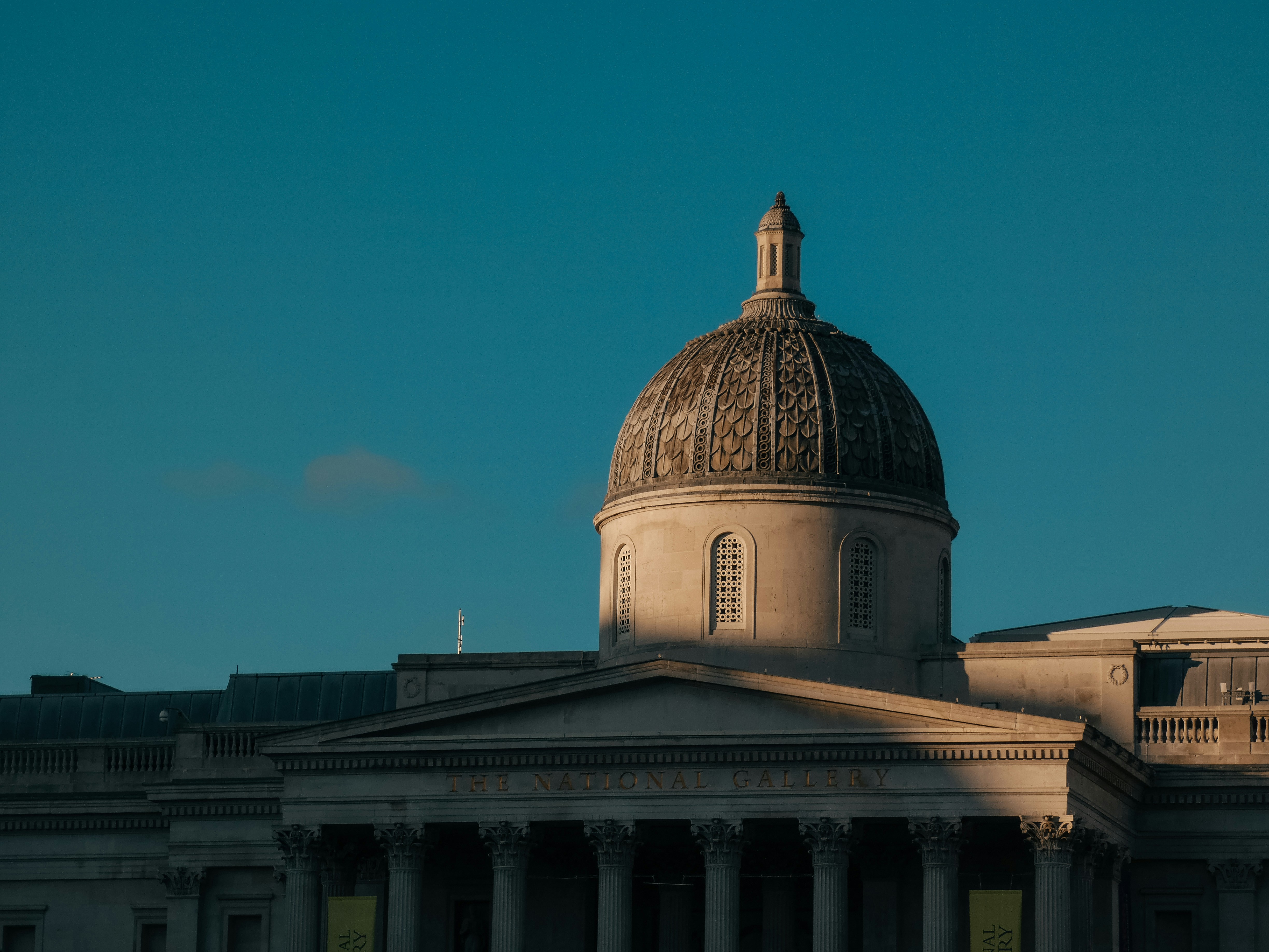 Grand dome of a historic building under a clear sky.
