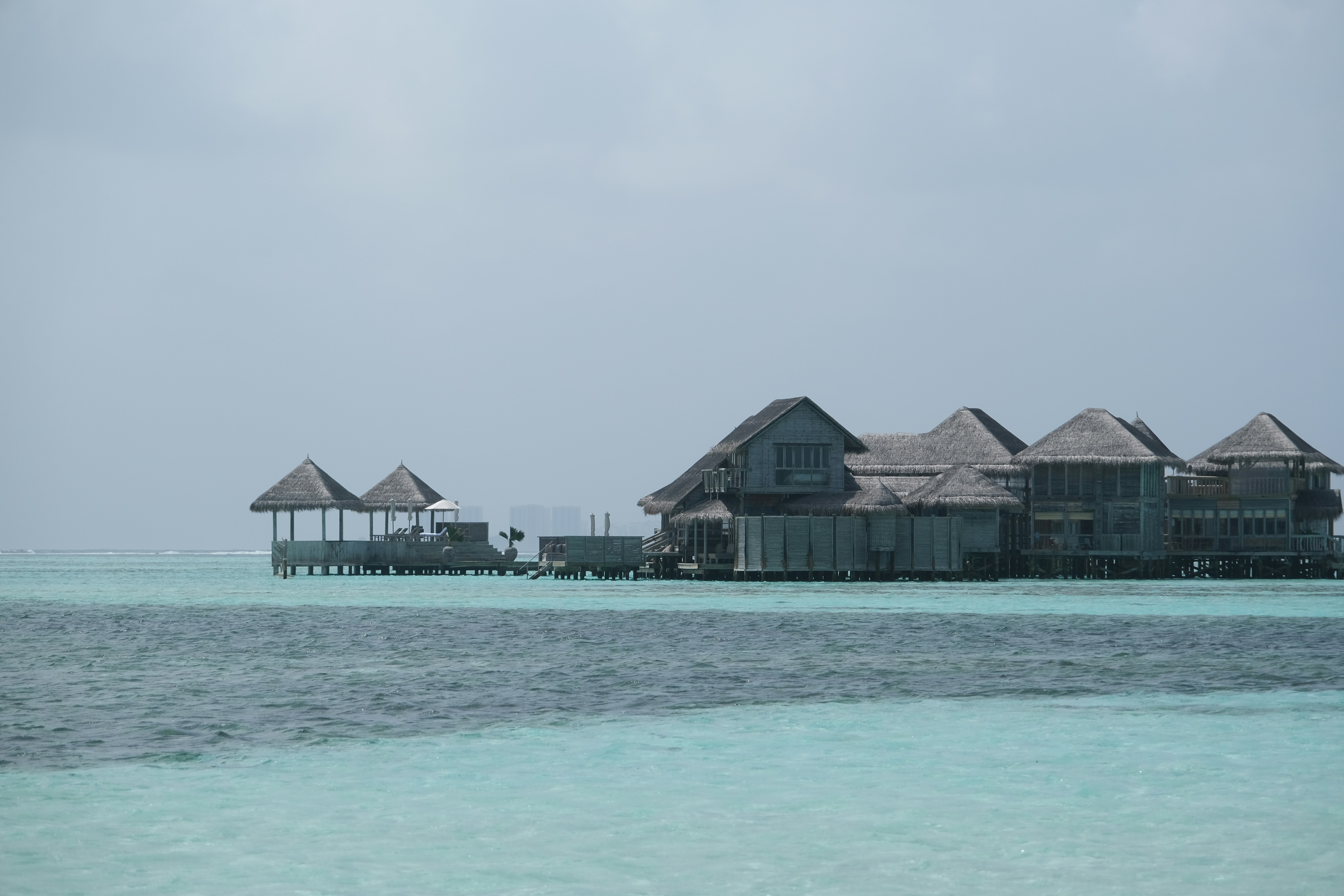 Überwasserbungalows an einem klaren türkisfarbenen Meer