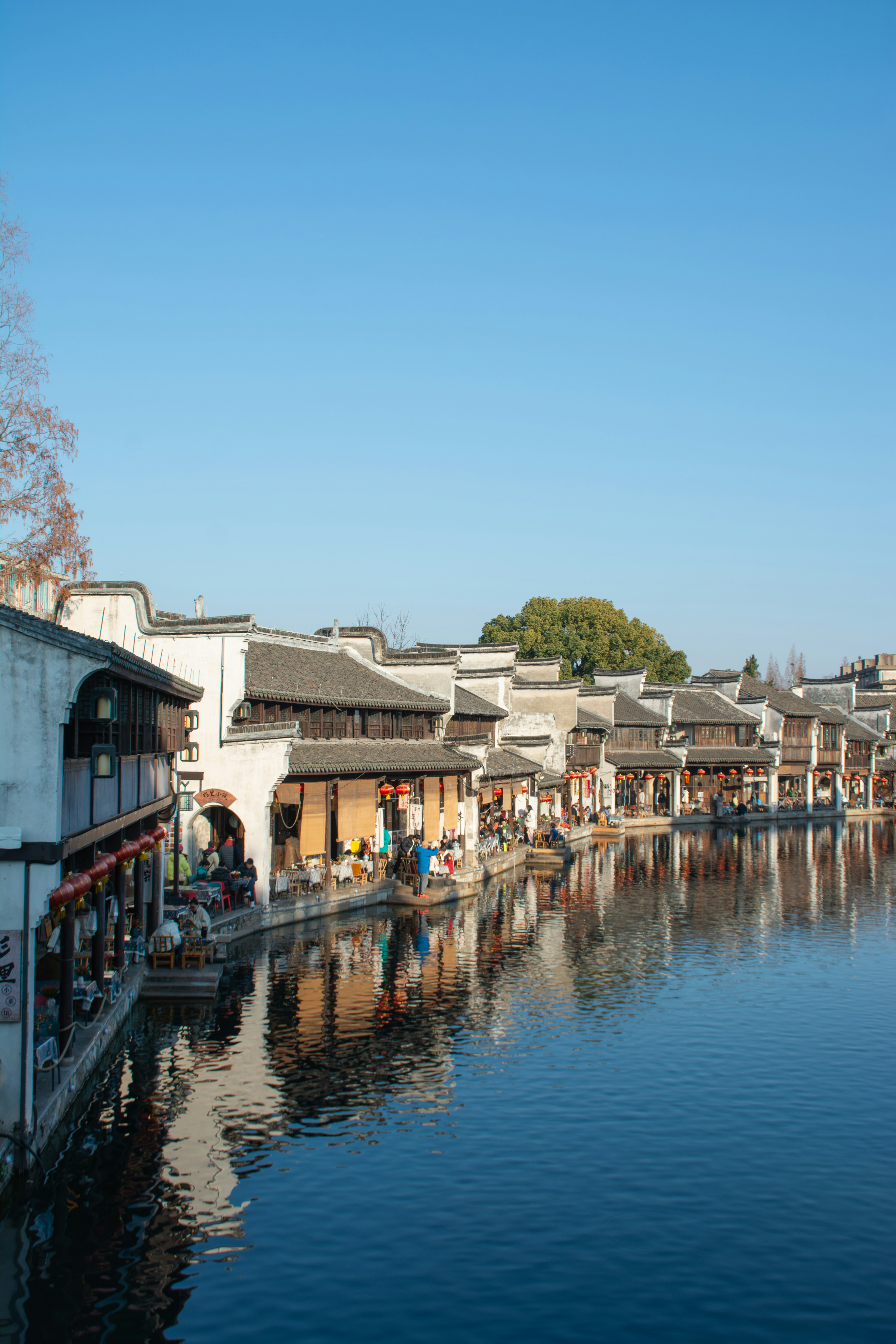 Traditional riverside buildings with reflections in water.