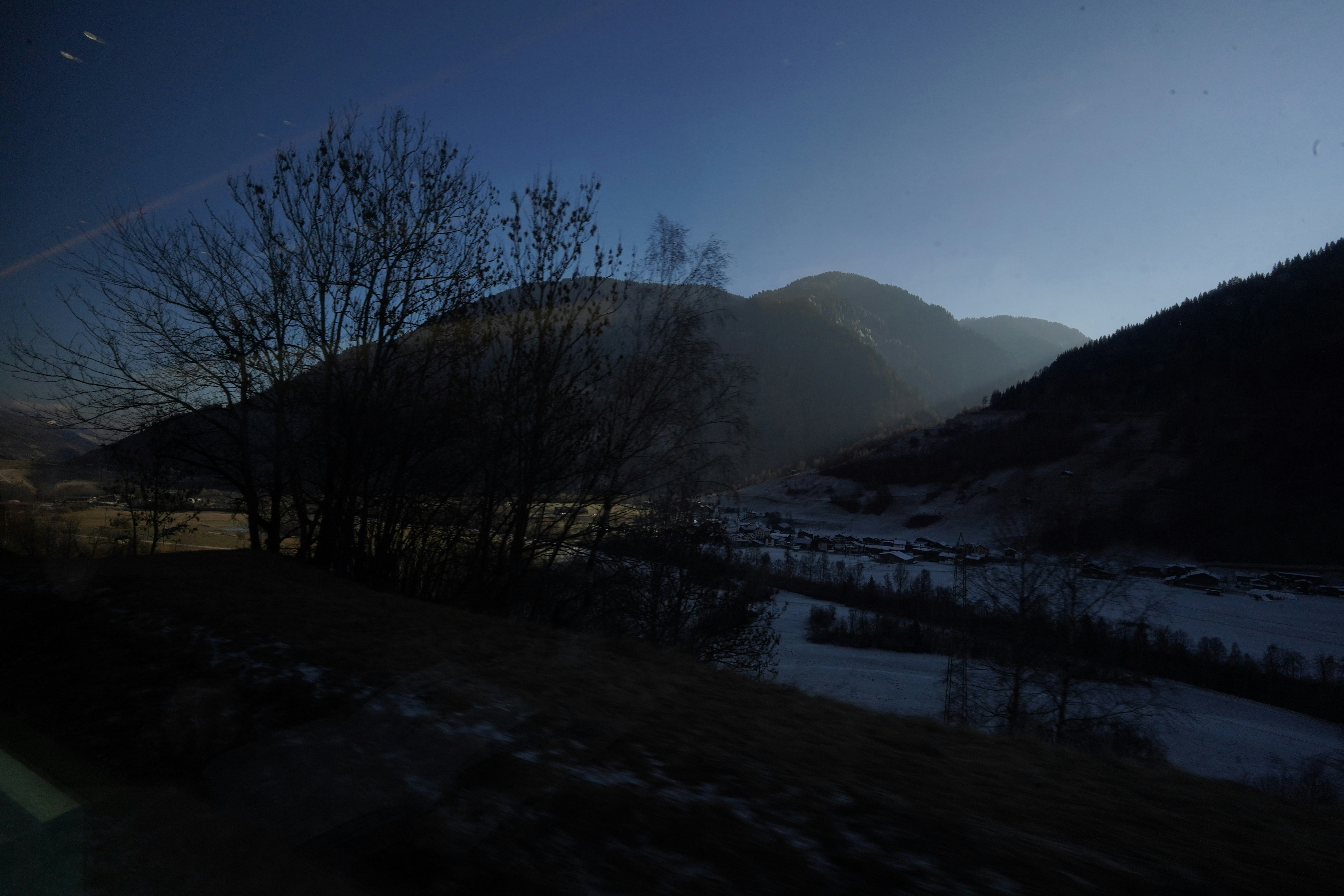 Dark, moody mountain valley at dusk