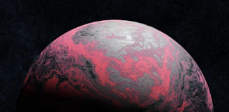 A pink and gray planet in dark space.