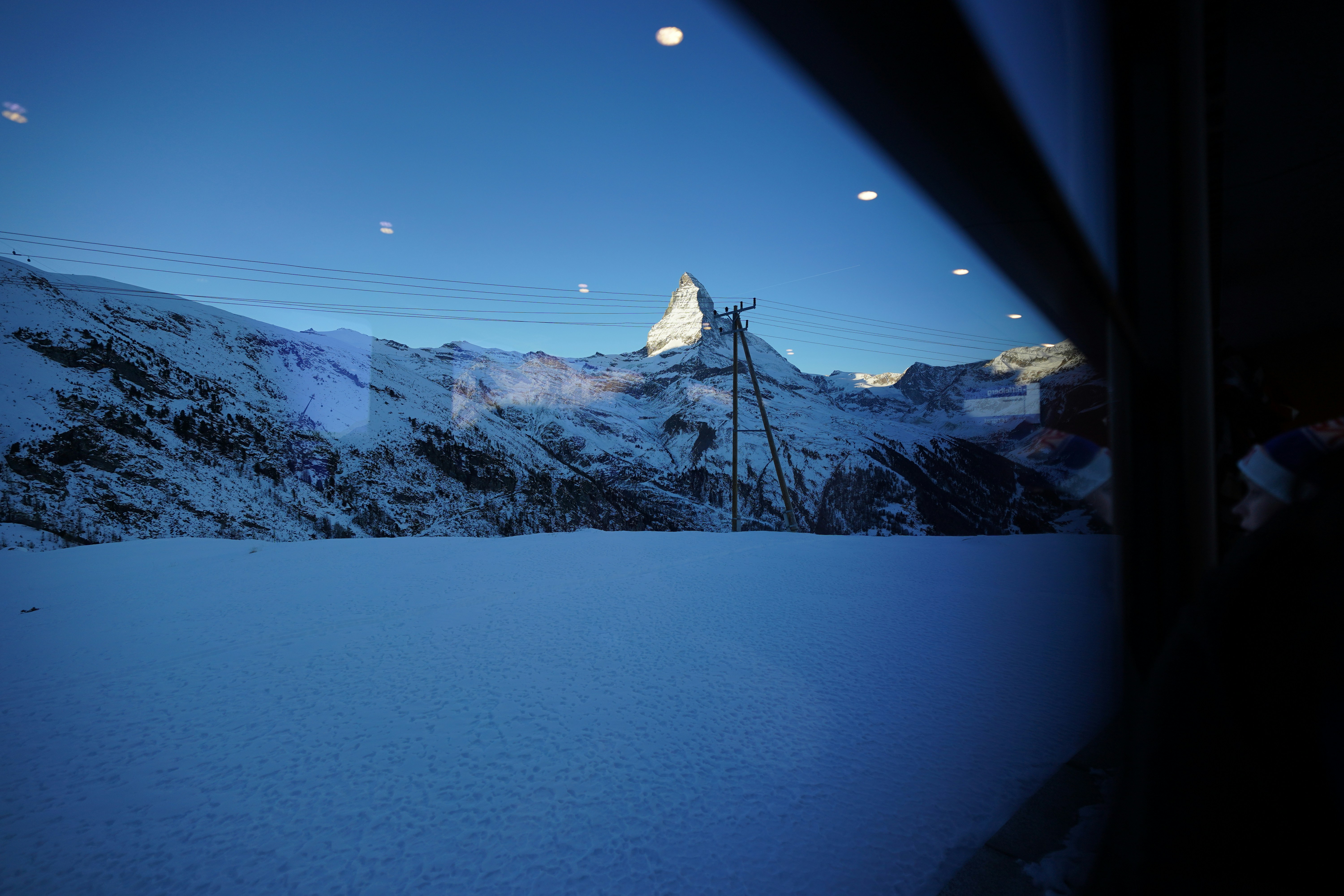 Snow covered mountain range under a clear blue sky