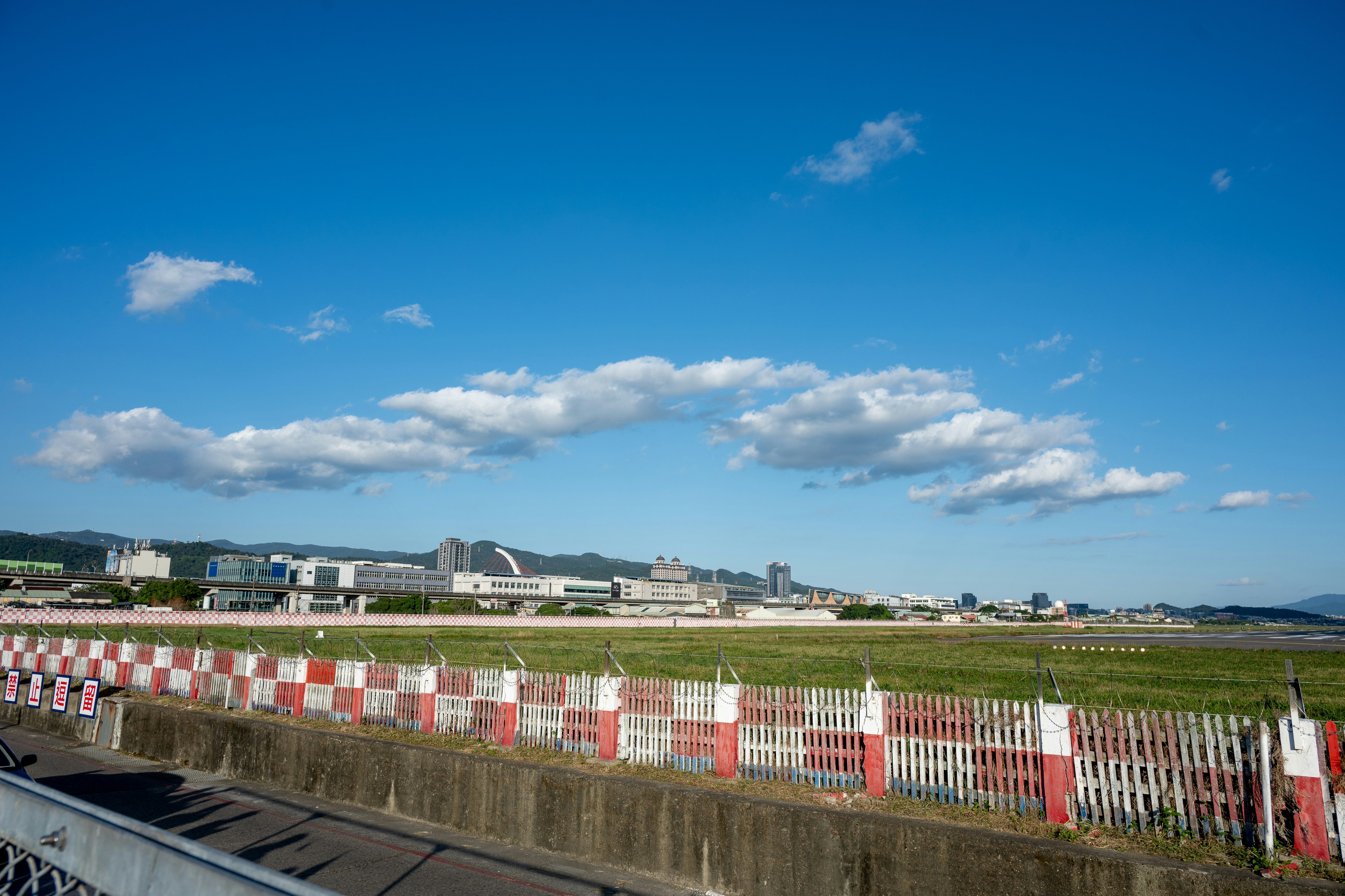 Red and white checkered fence along airport runway