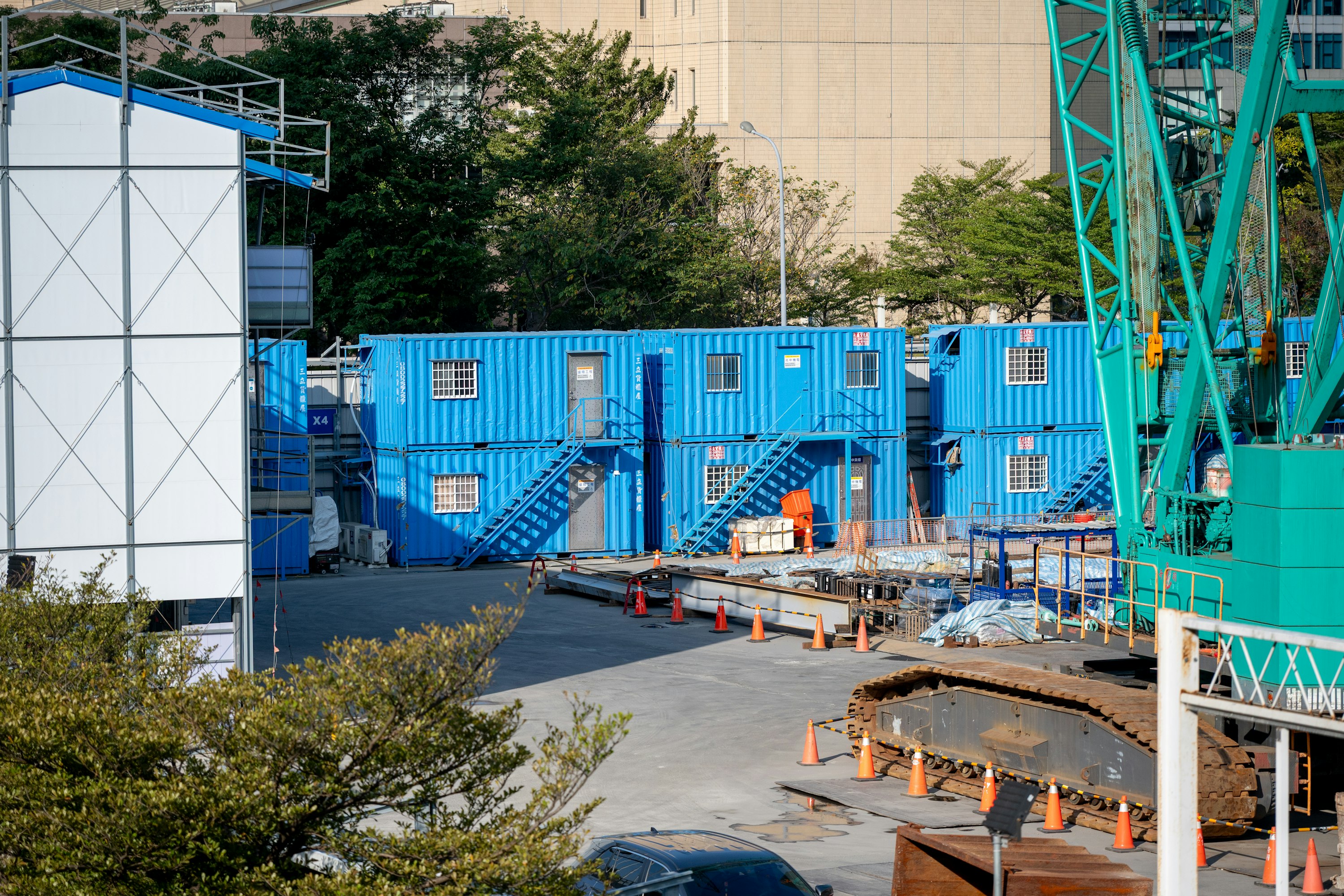 Blue modular buildings at a construction site