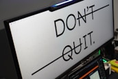 Computer monitor displays 'don't quit.' message.