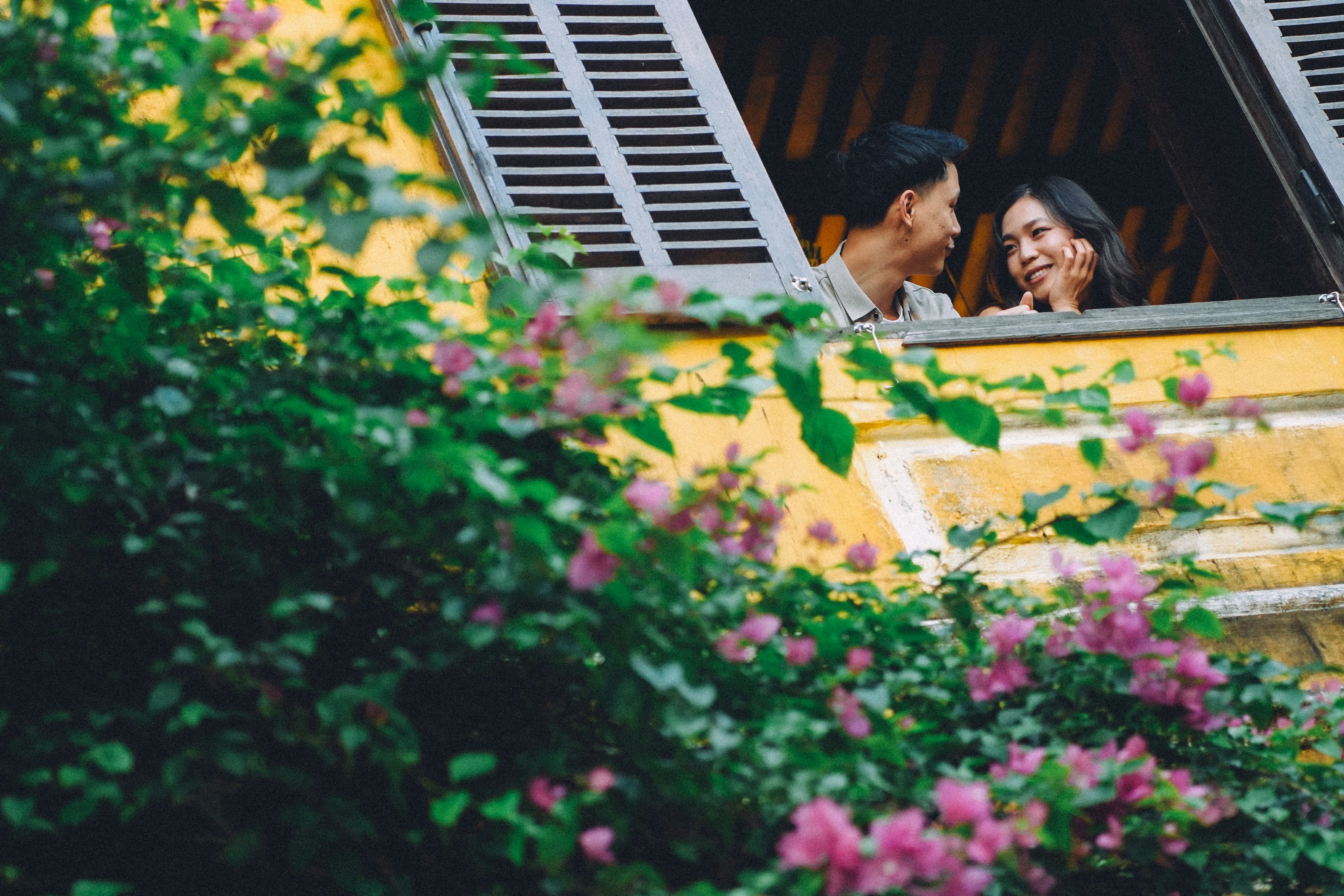 Couple looking at each other from a window