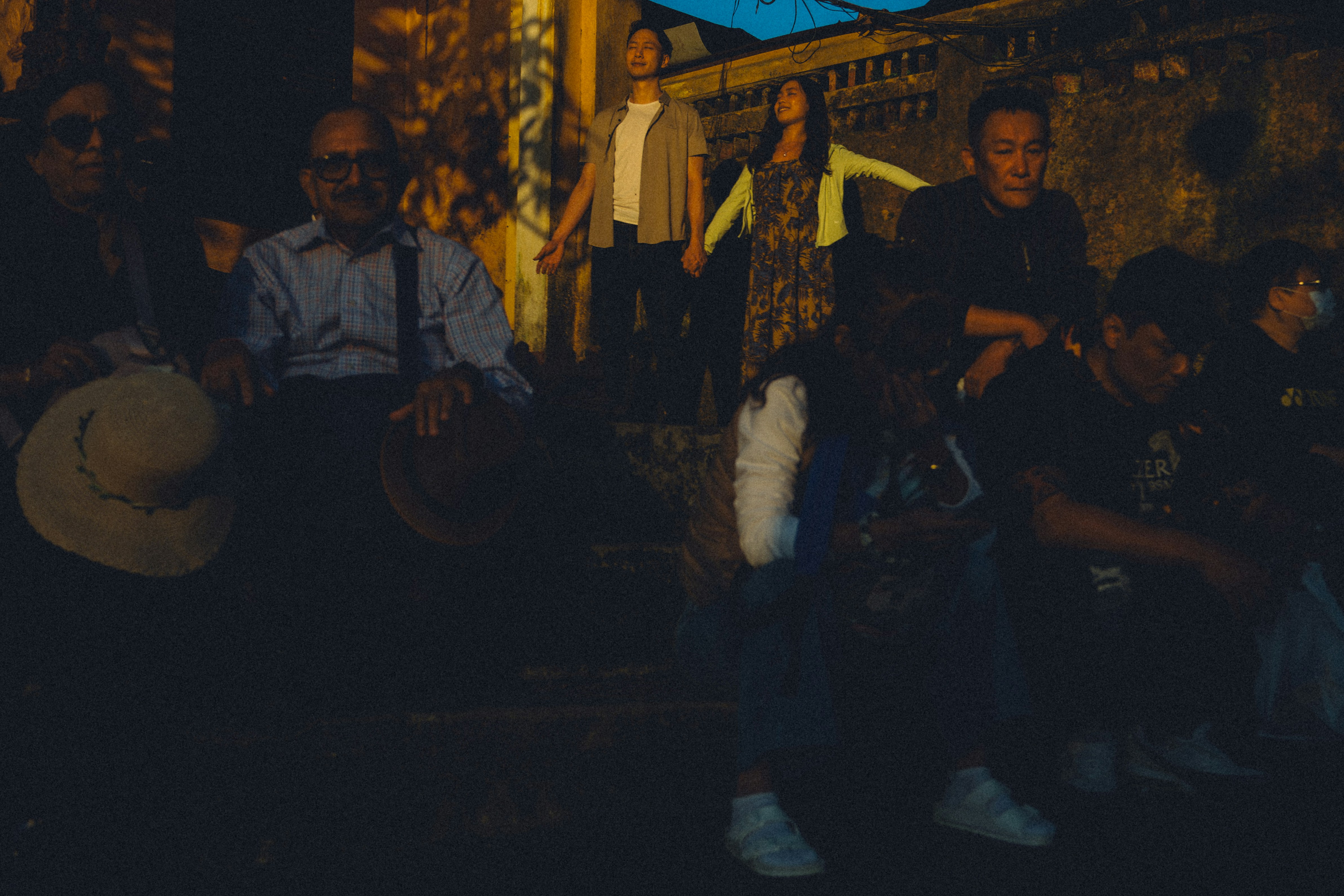 A group of people gathered outdoors at night.