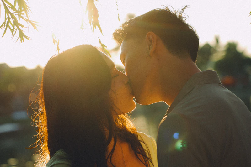 Couple kissing during golden hour sunset