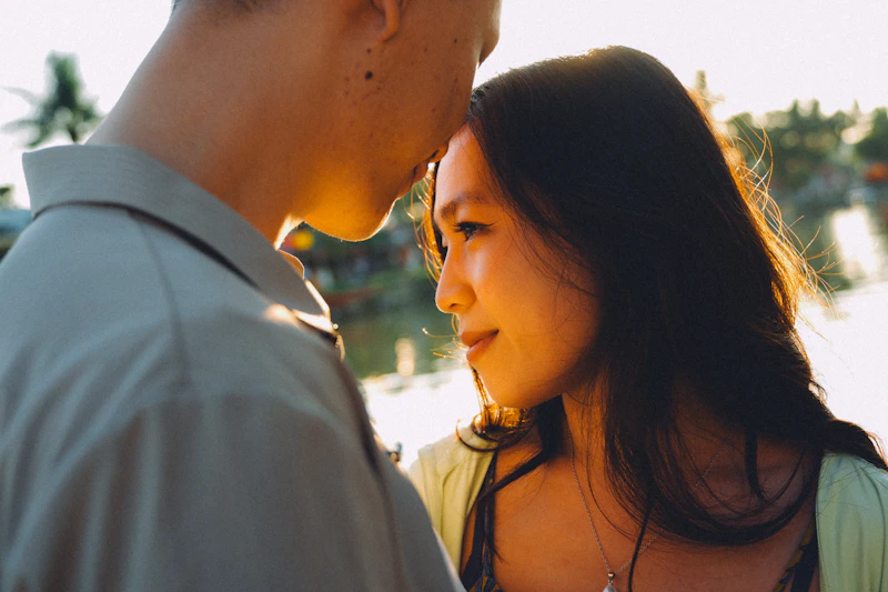 HPV-positive couple embracing at sunset