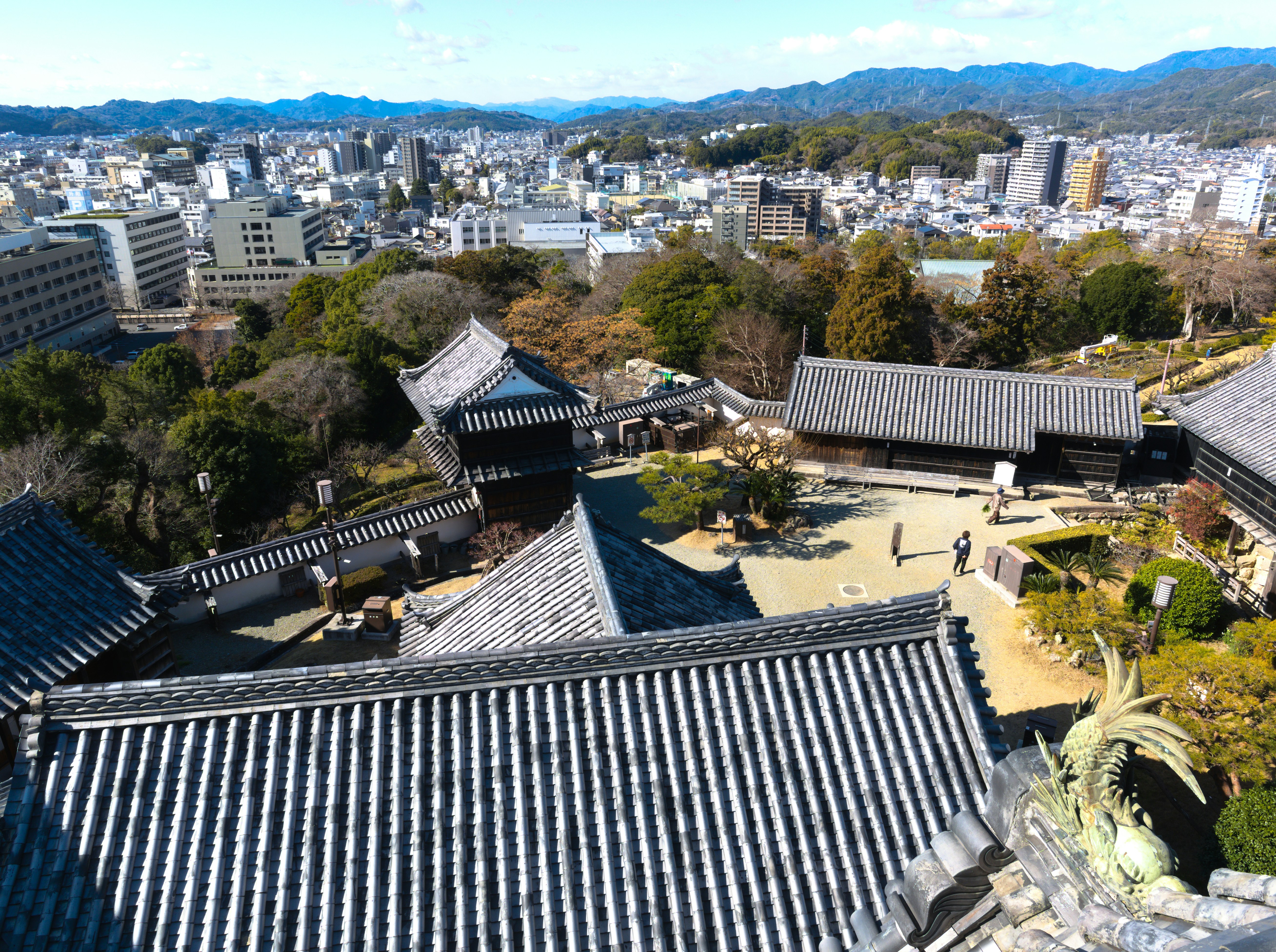 Panoramic view of a historic japanese castle and cityscape.