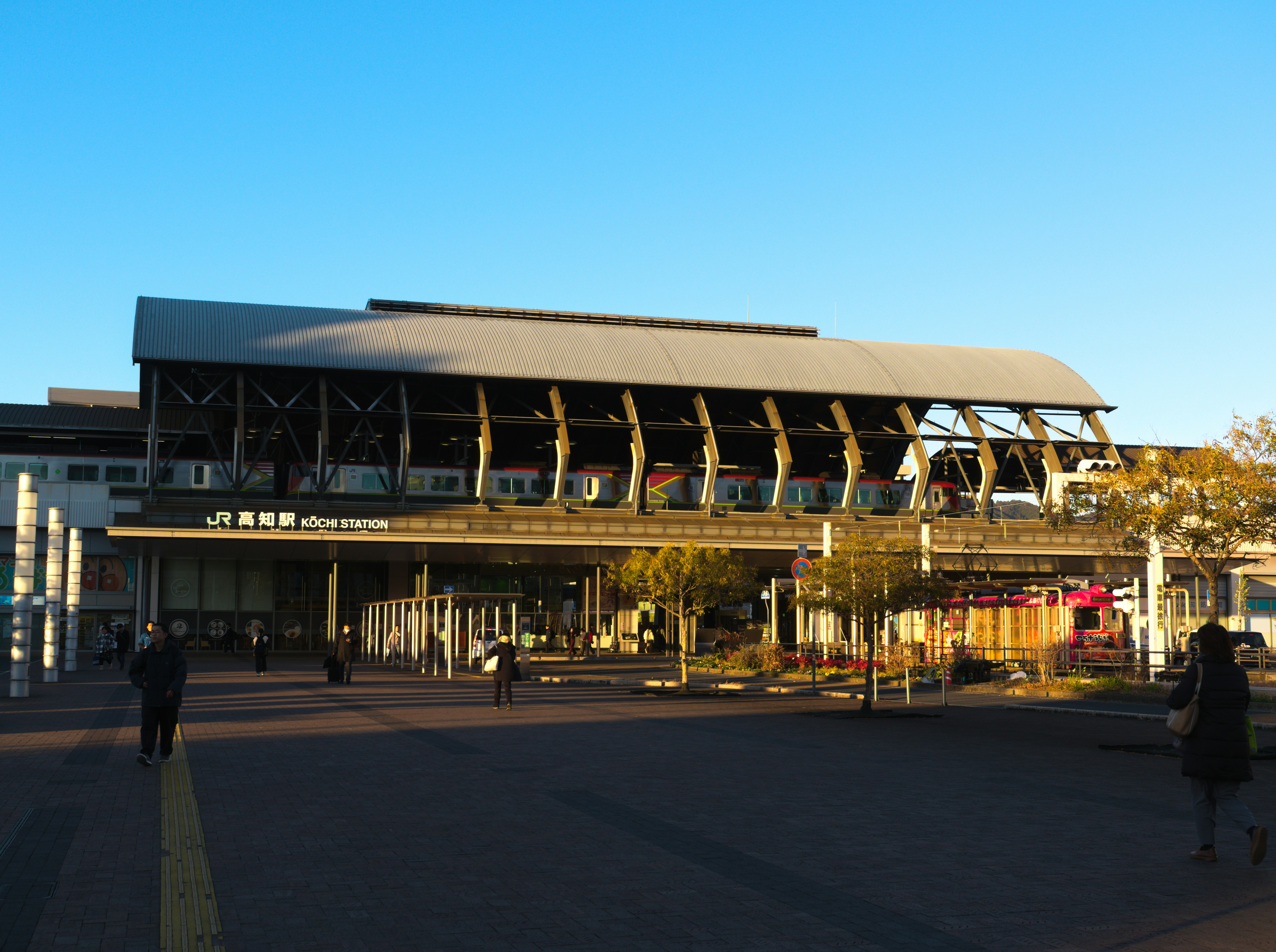 Modern train station building with clear blue sky.