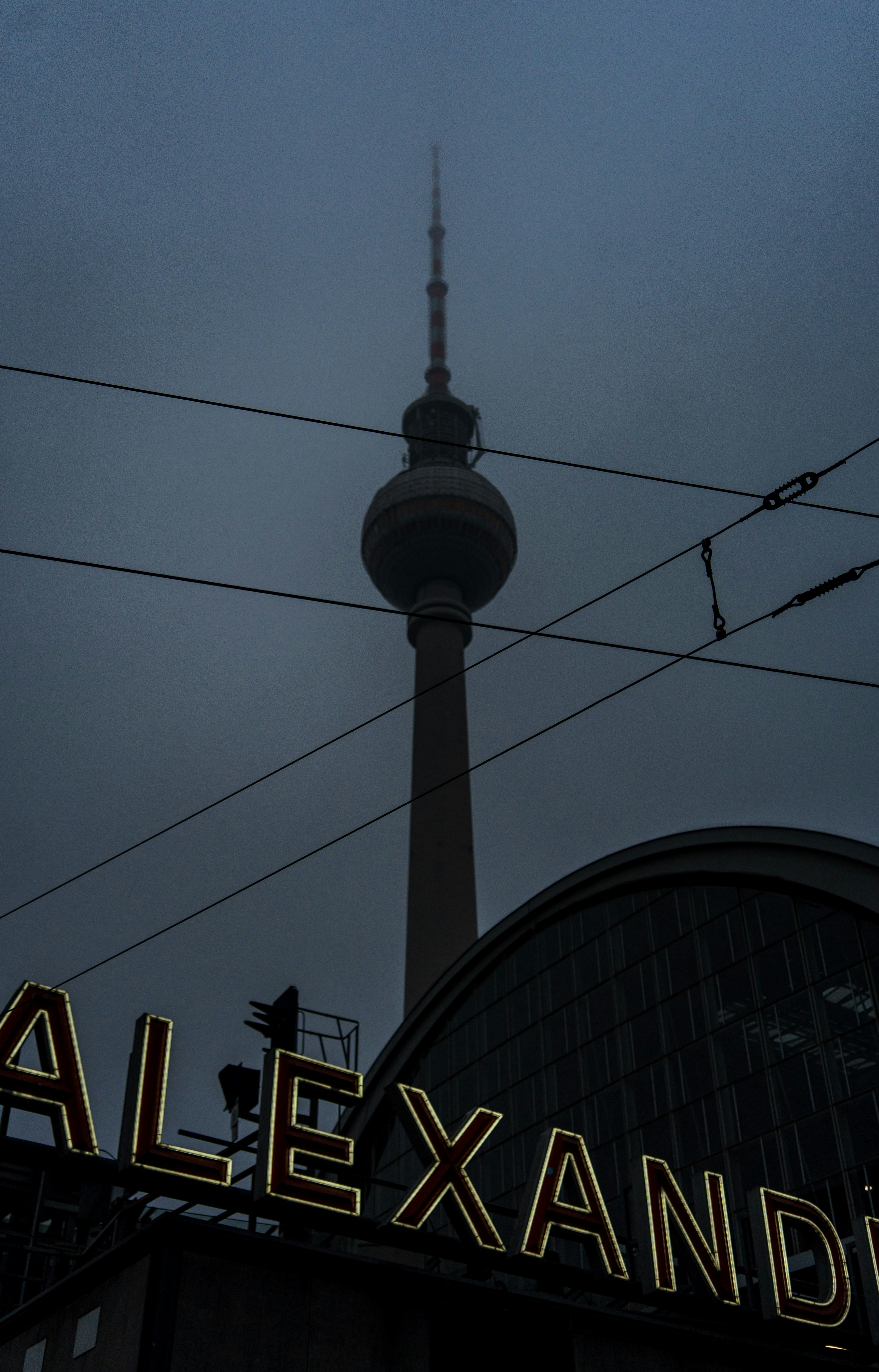 Berlin's TV tower looms over alexanderplatz at dusk