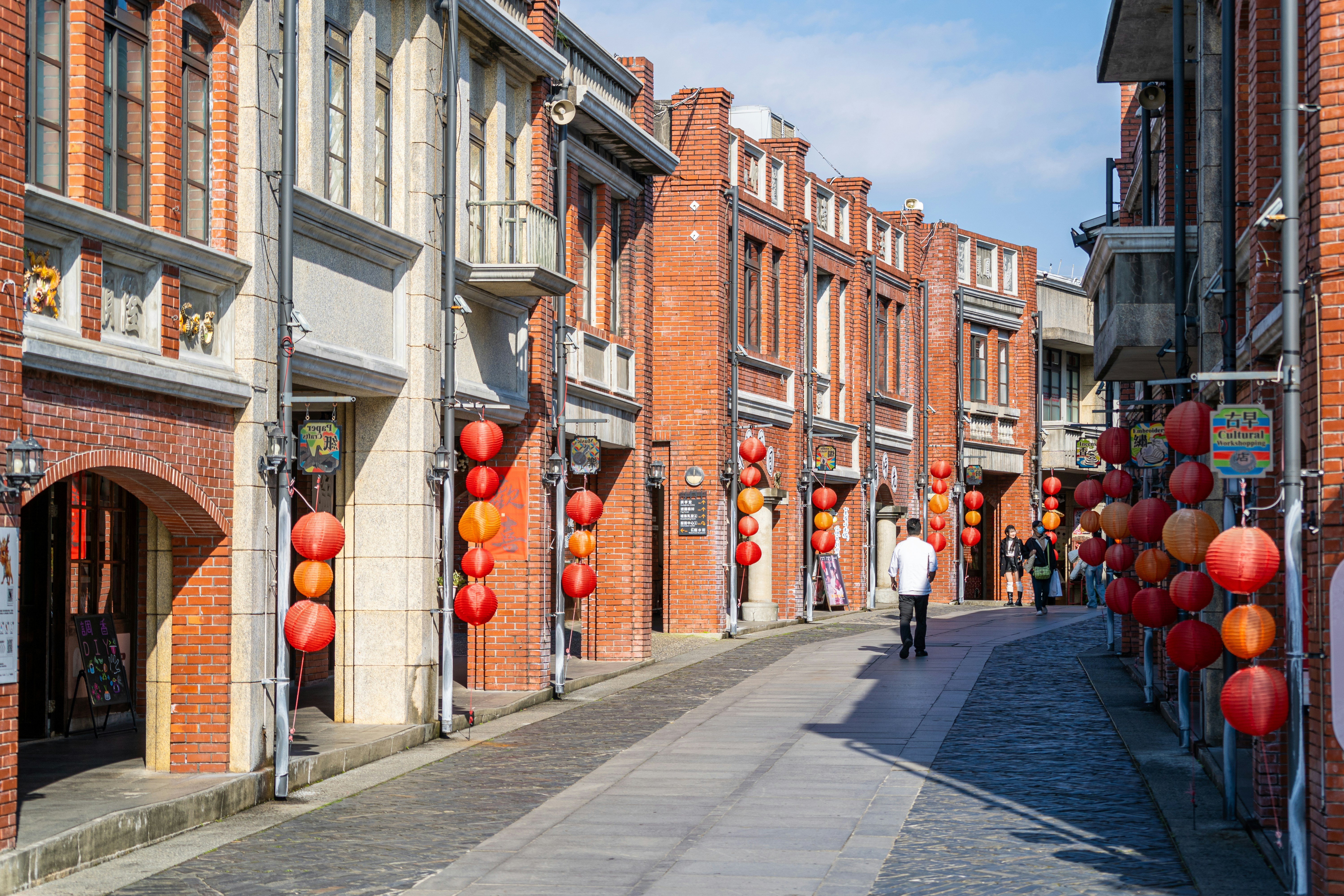 Street lined with brick buildings and red lanterns
