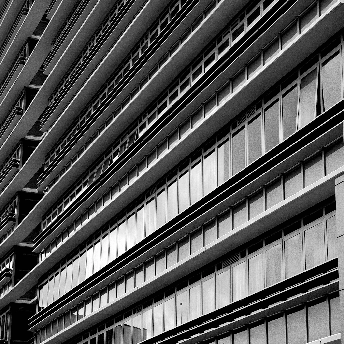Black and white close-up of a modern Sydney office building facade with repeating windows