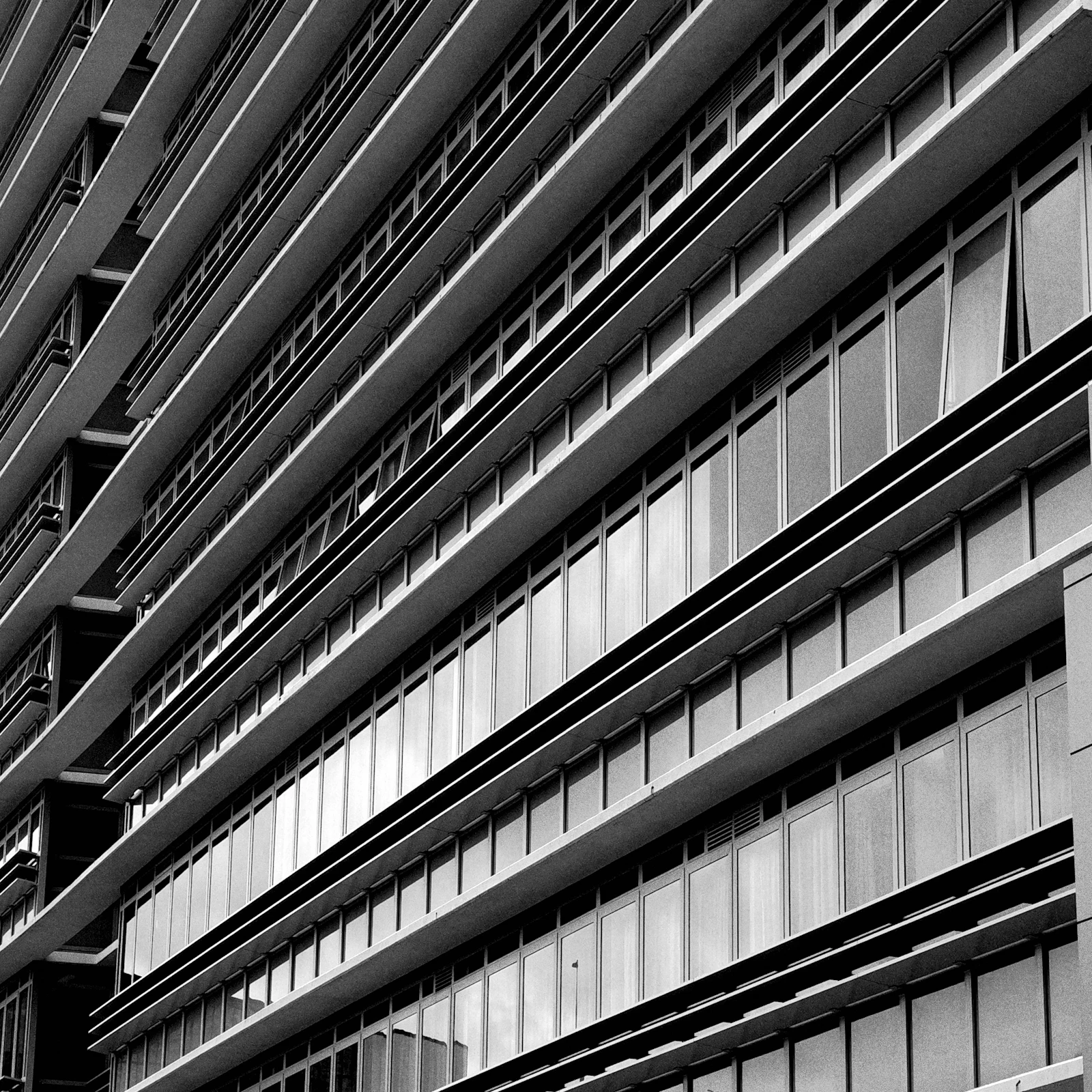 Black and white close-up of a modern Sydney office building facade with repeating windows