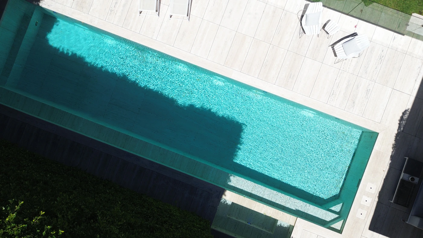 Top view showing modern pool steps and surrounding deck