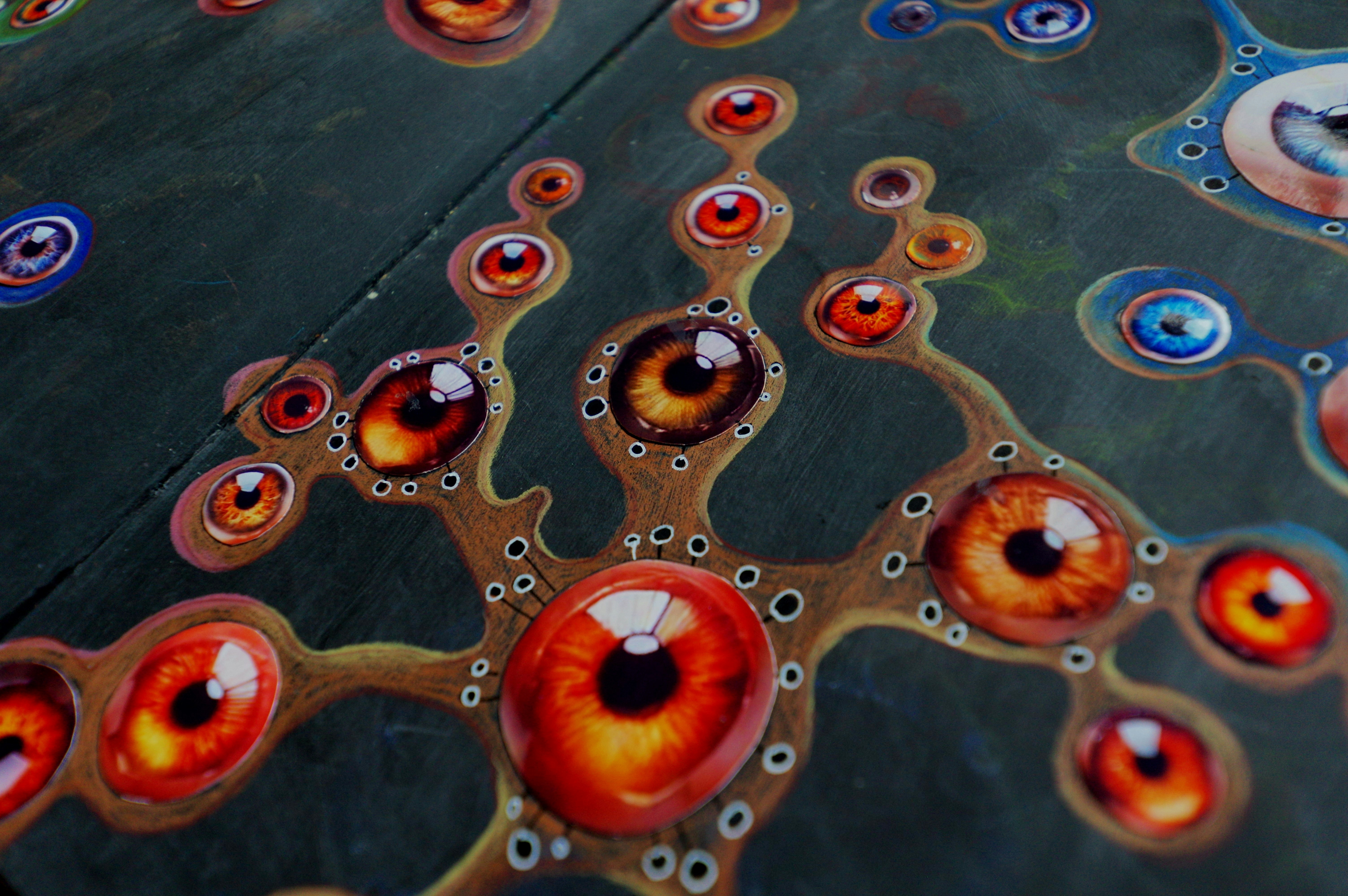 Abstract pattern of many eyes on a dark background