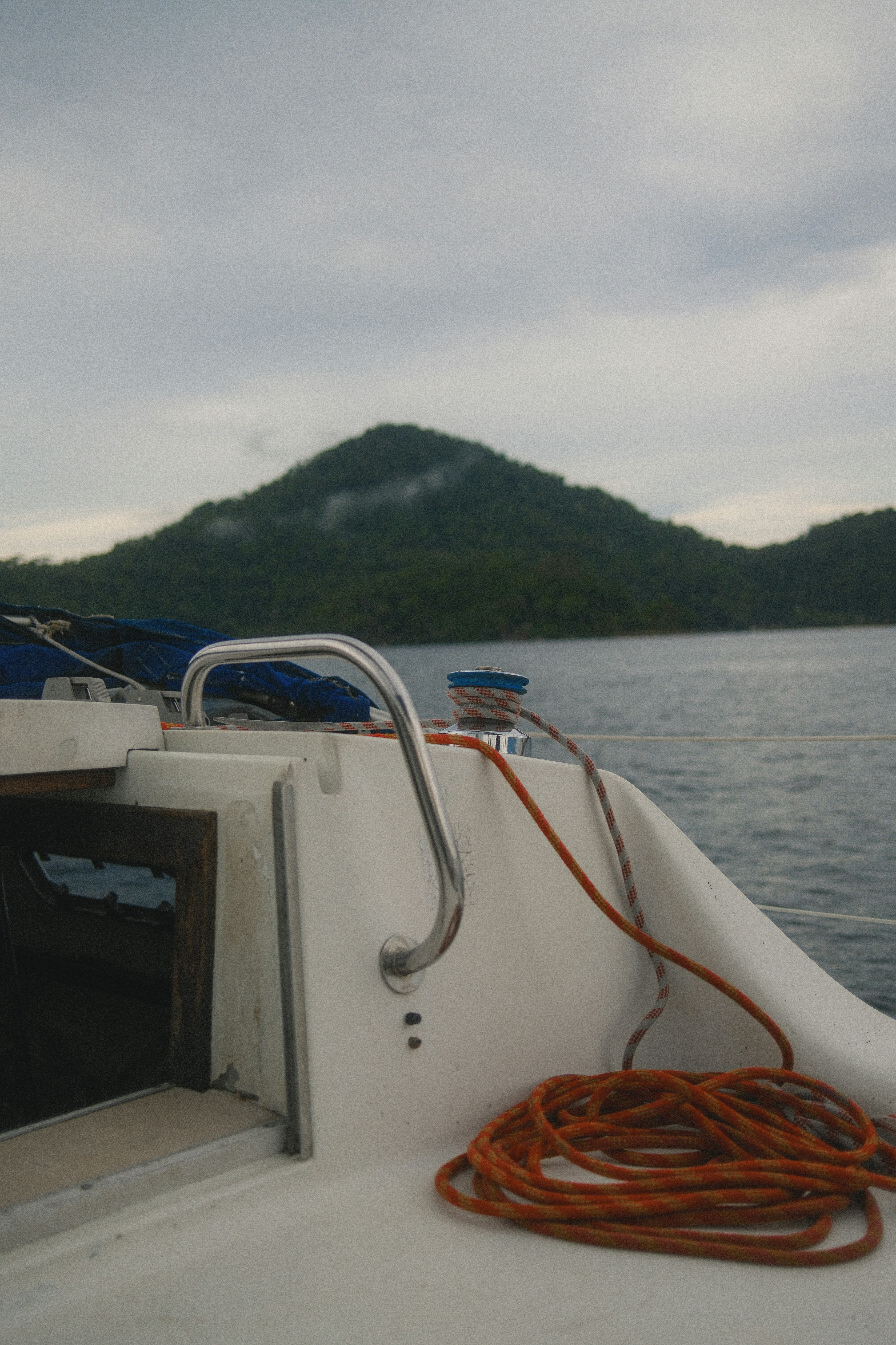 Boat moving towards a lush green island