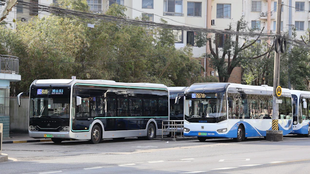 Two modern buses parked at a station.