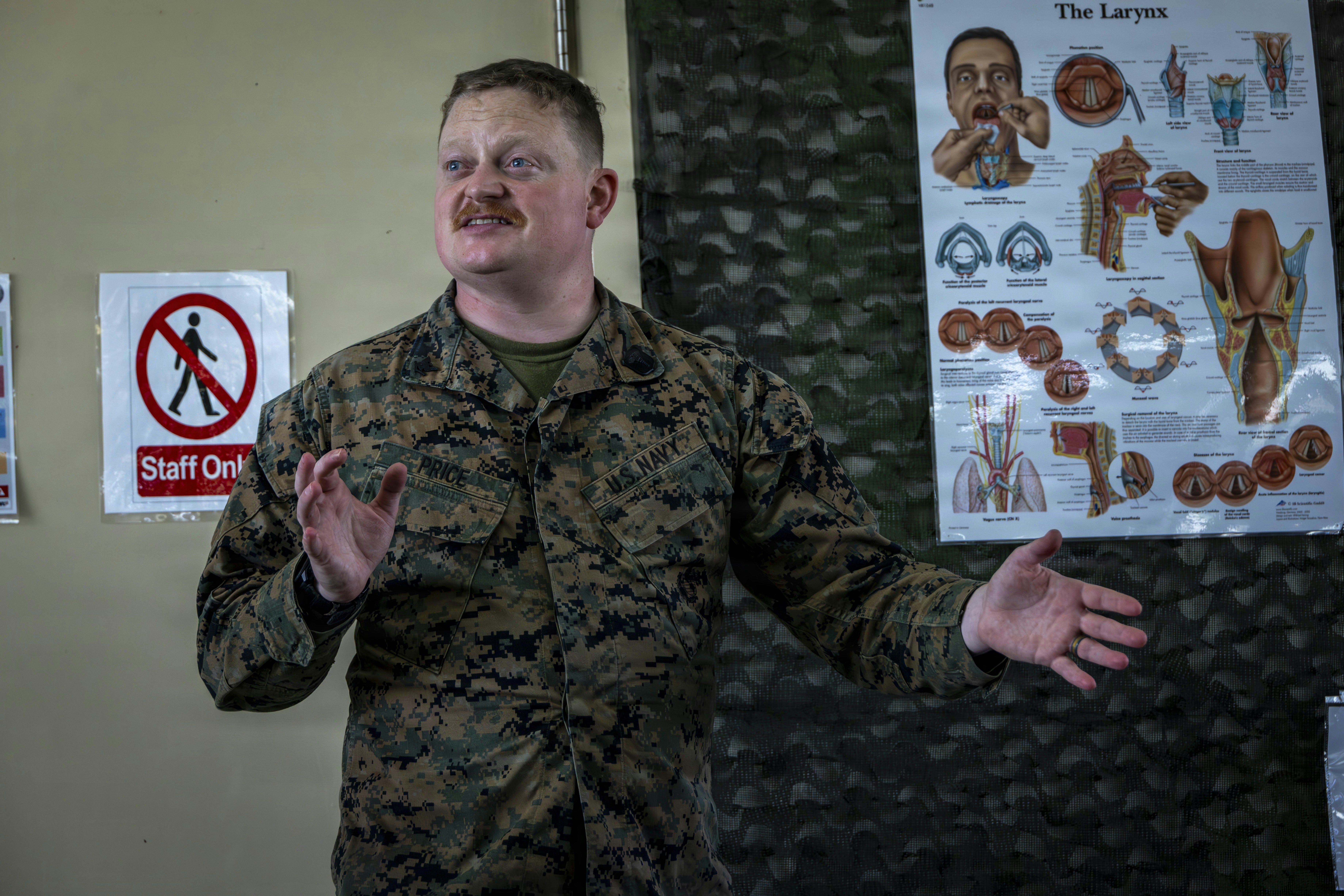 Marine con uniforme hace gestos mientras enseña