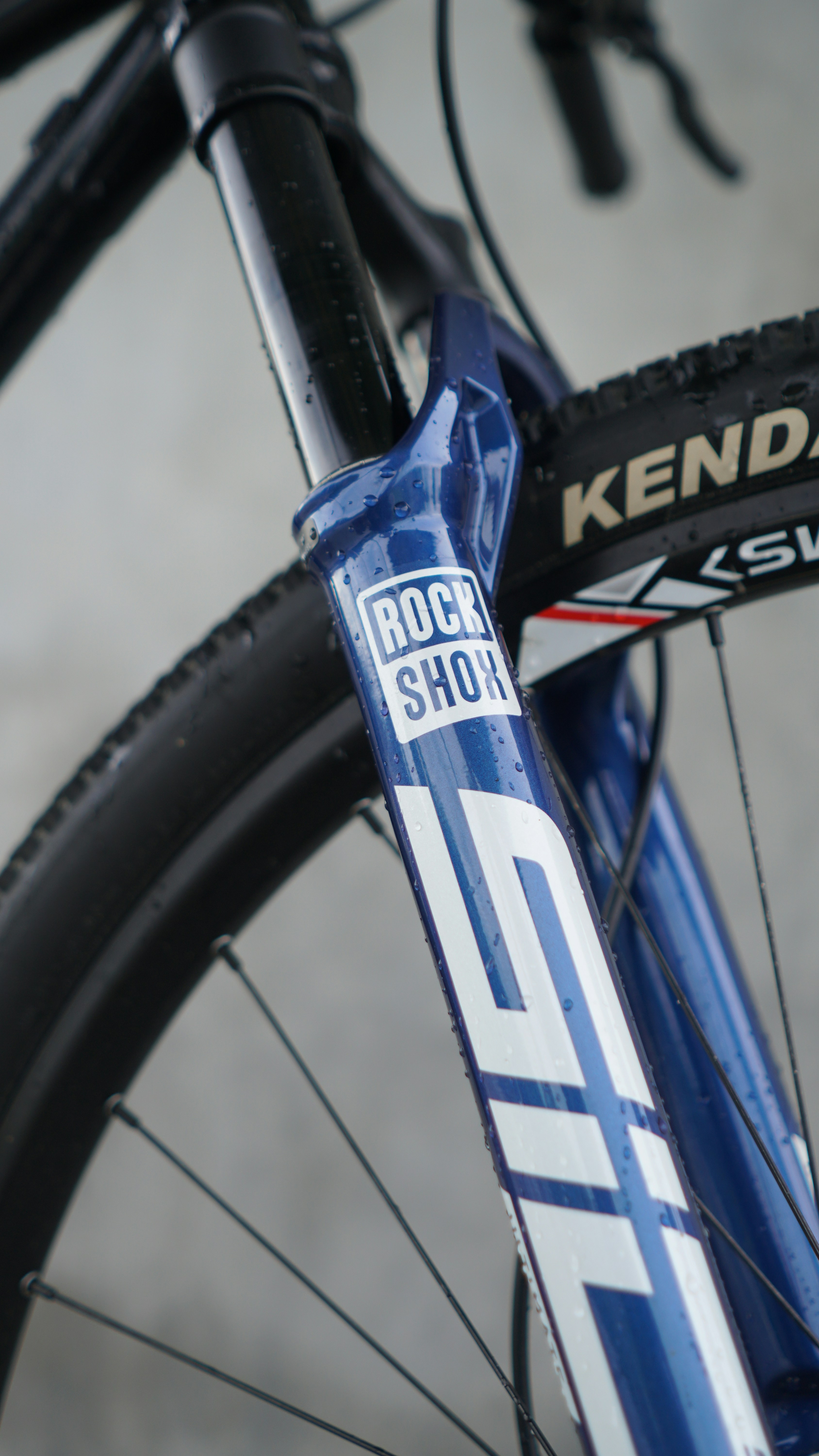 Blue mountain bike fork with rock shox logo.