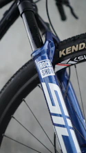 Blue mountain bike fork with rock shox logo.