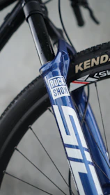 Blue mountain bike fork with rock shox logo.