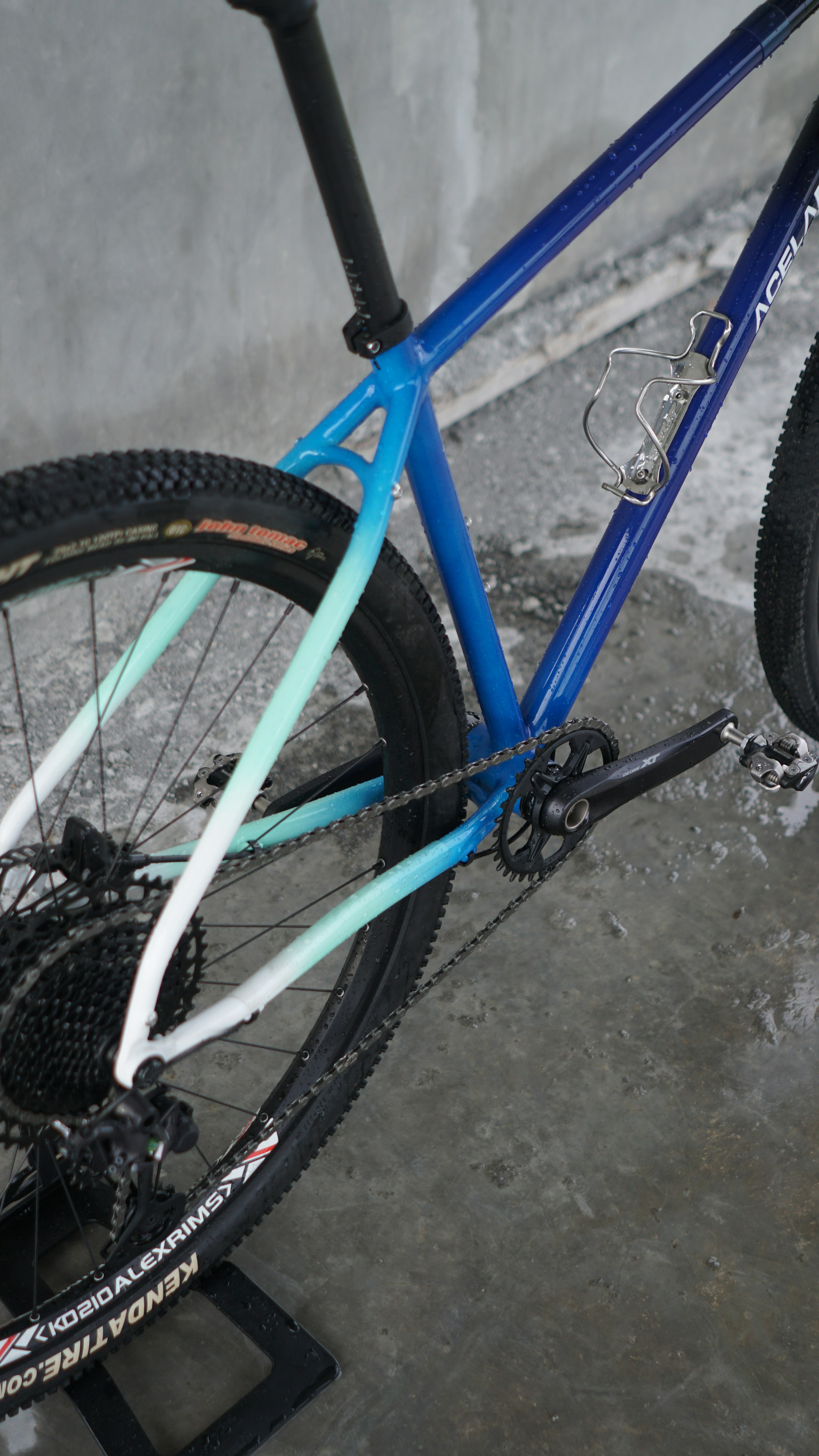 Blue and white gradient bicycle frame with gears and wheels