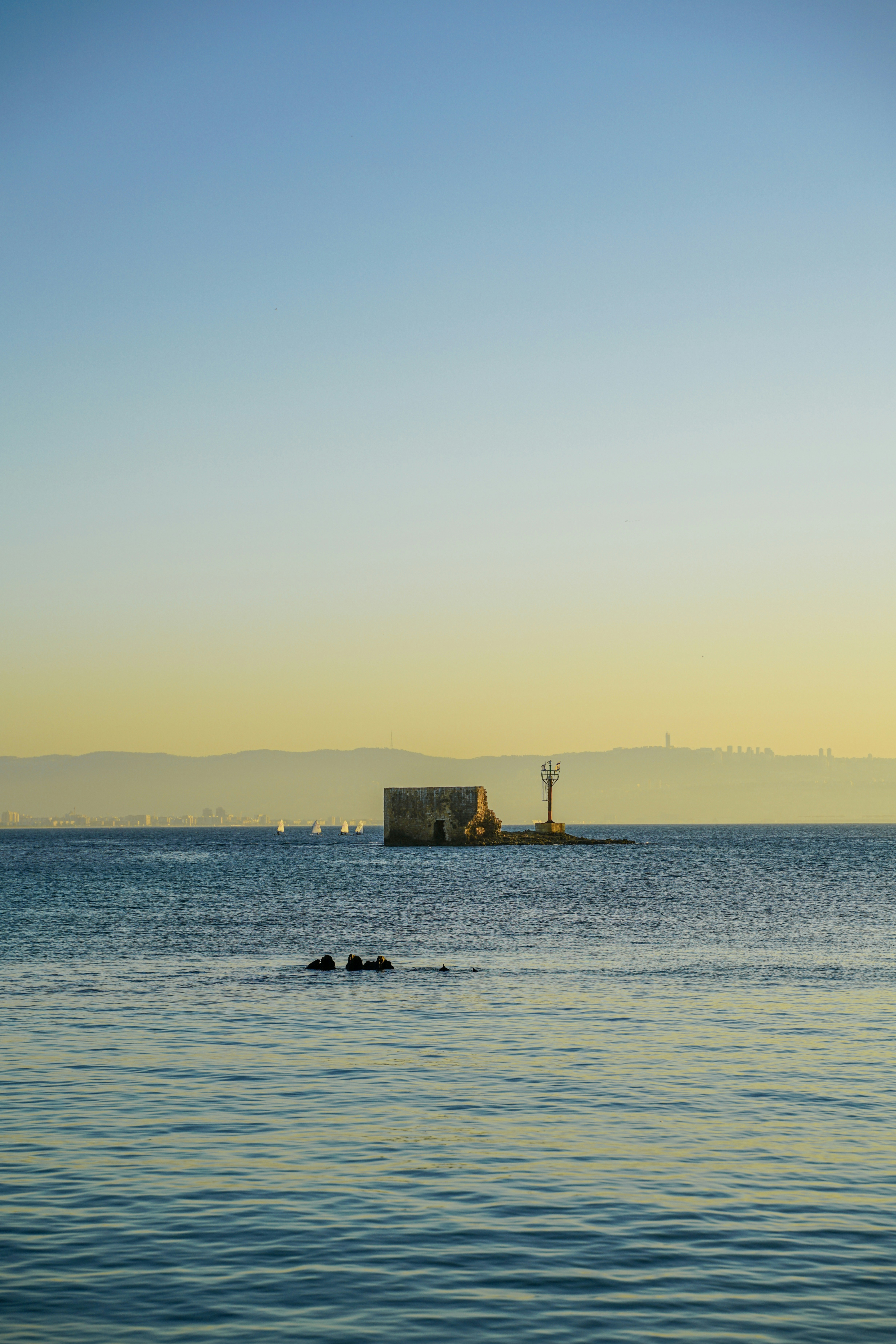 Small stone structure on an island in the sea.