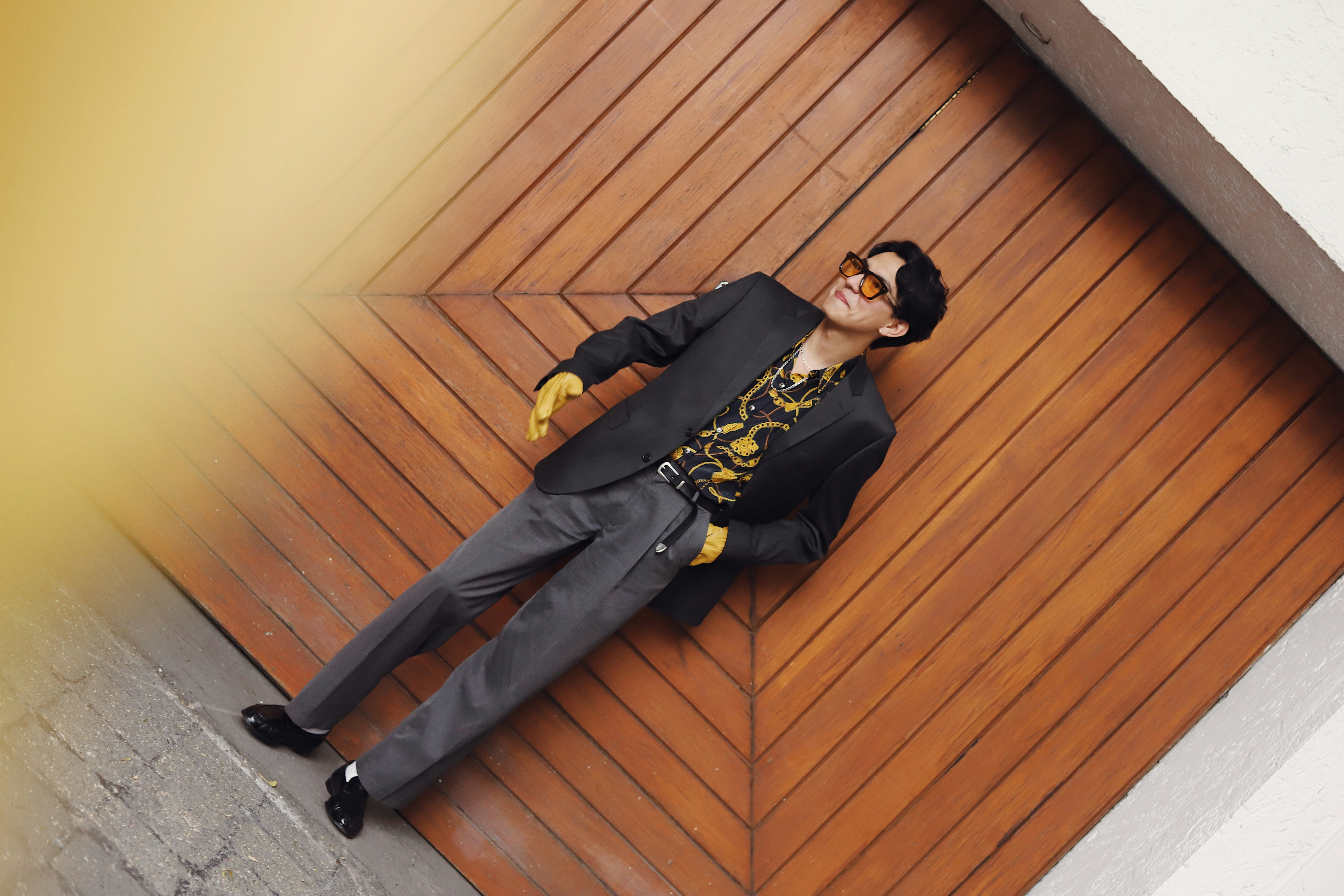 Man in suit and sunglasses on wooden background