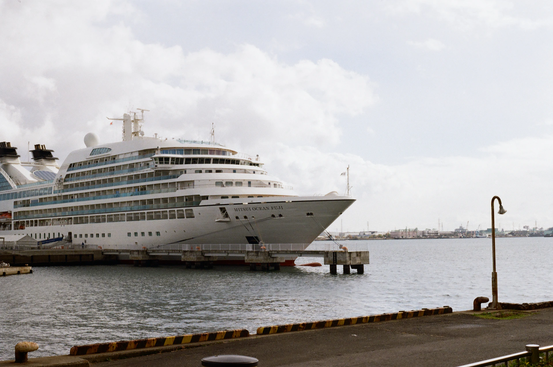 A large white cruise ship docked at a pier