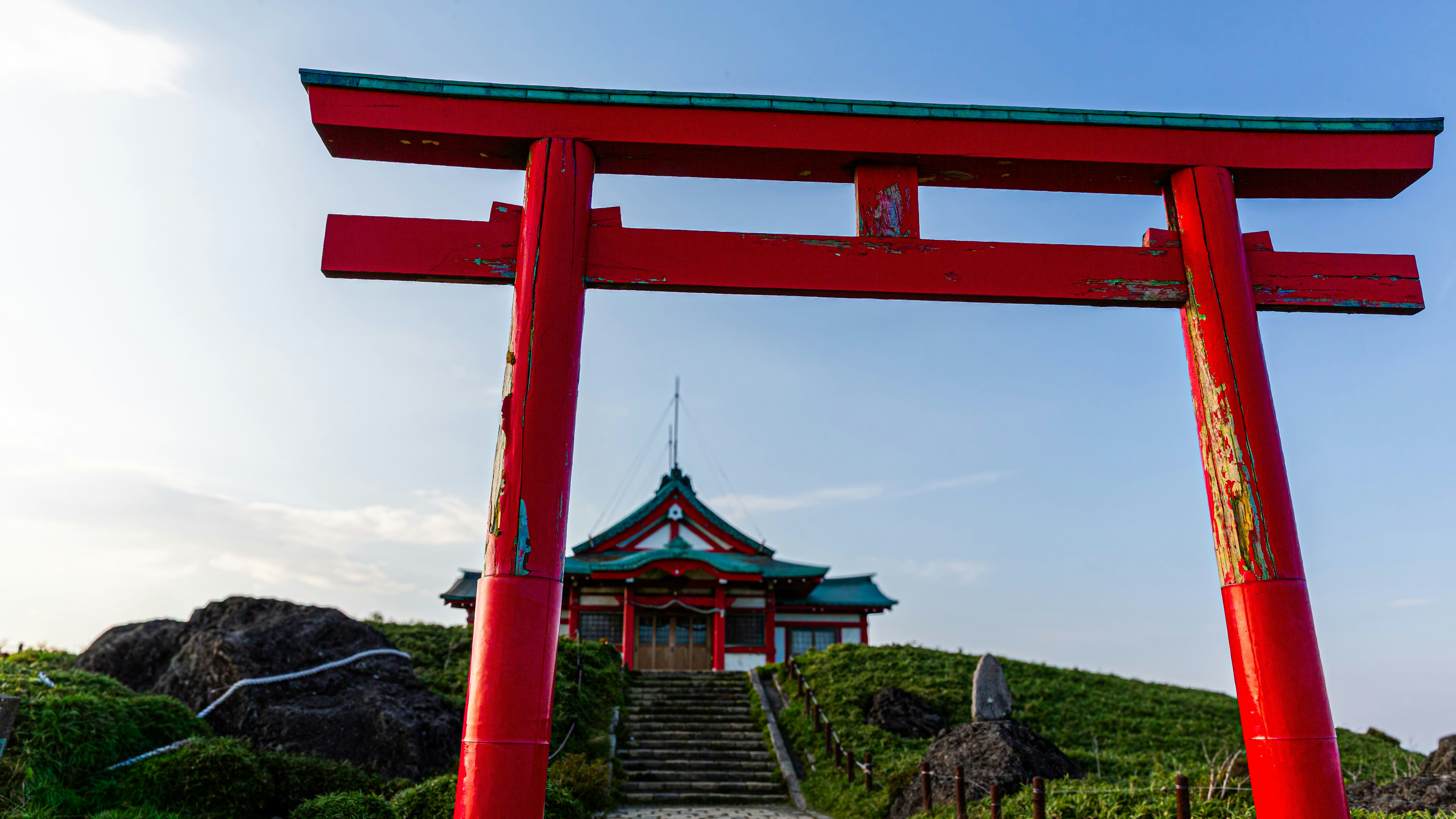 Porta torii rossa con santuario sulla collina