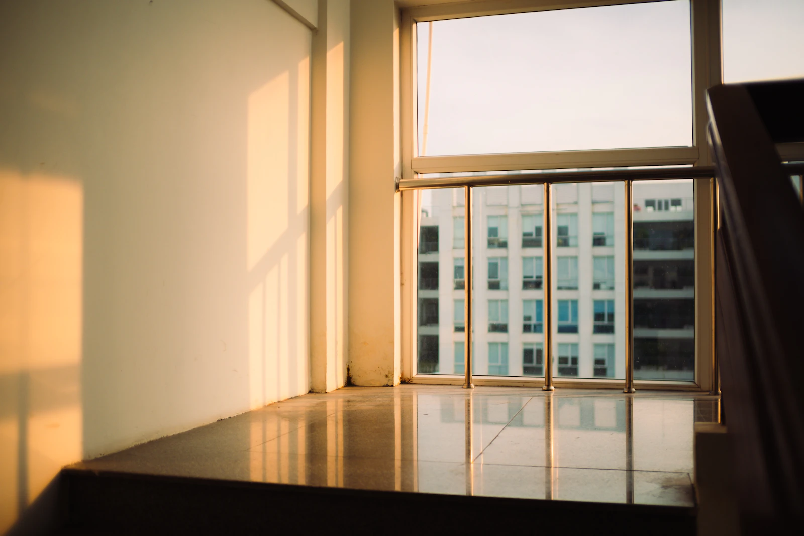 Sunlight falling through a tall window onto a bare floor
