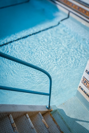 Steps leading into a clear blue residential pool