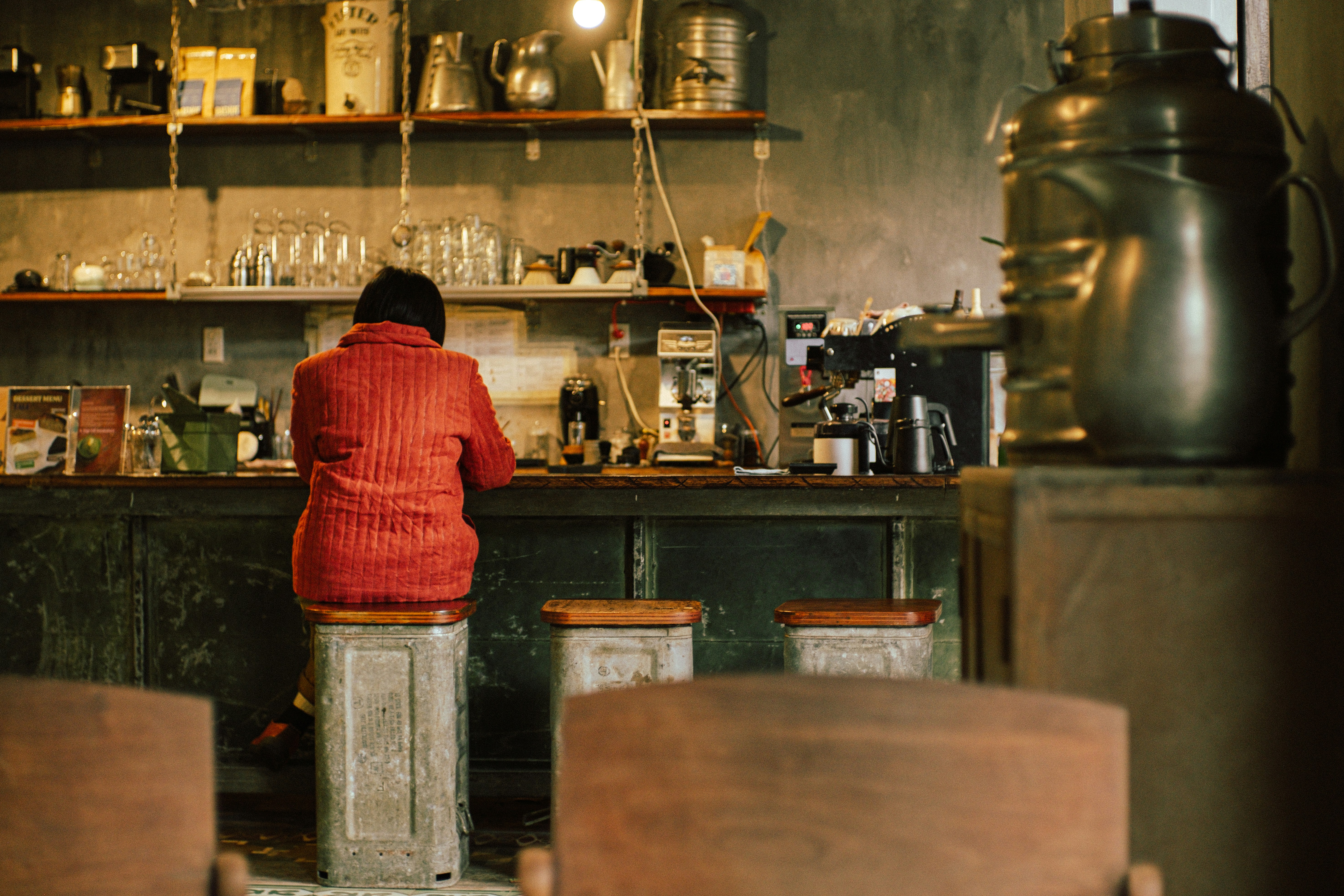 Person sits at a vintage diner counter.